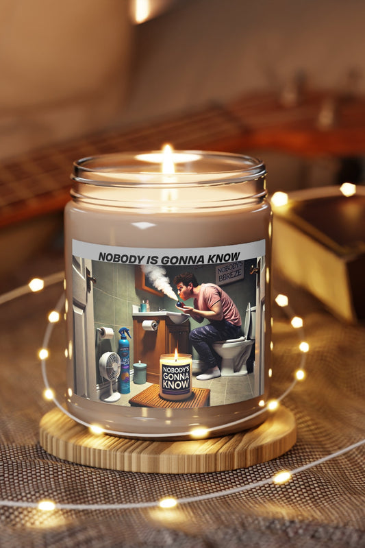Lit Nobody Is Gonna Know soy candle on wooden table with string lights