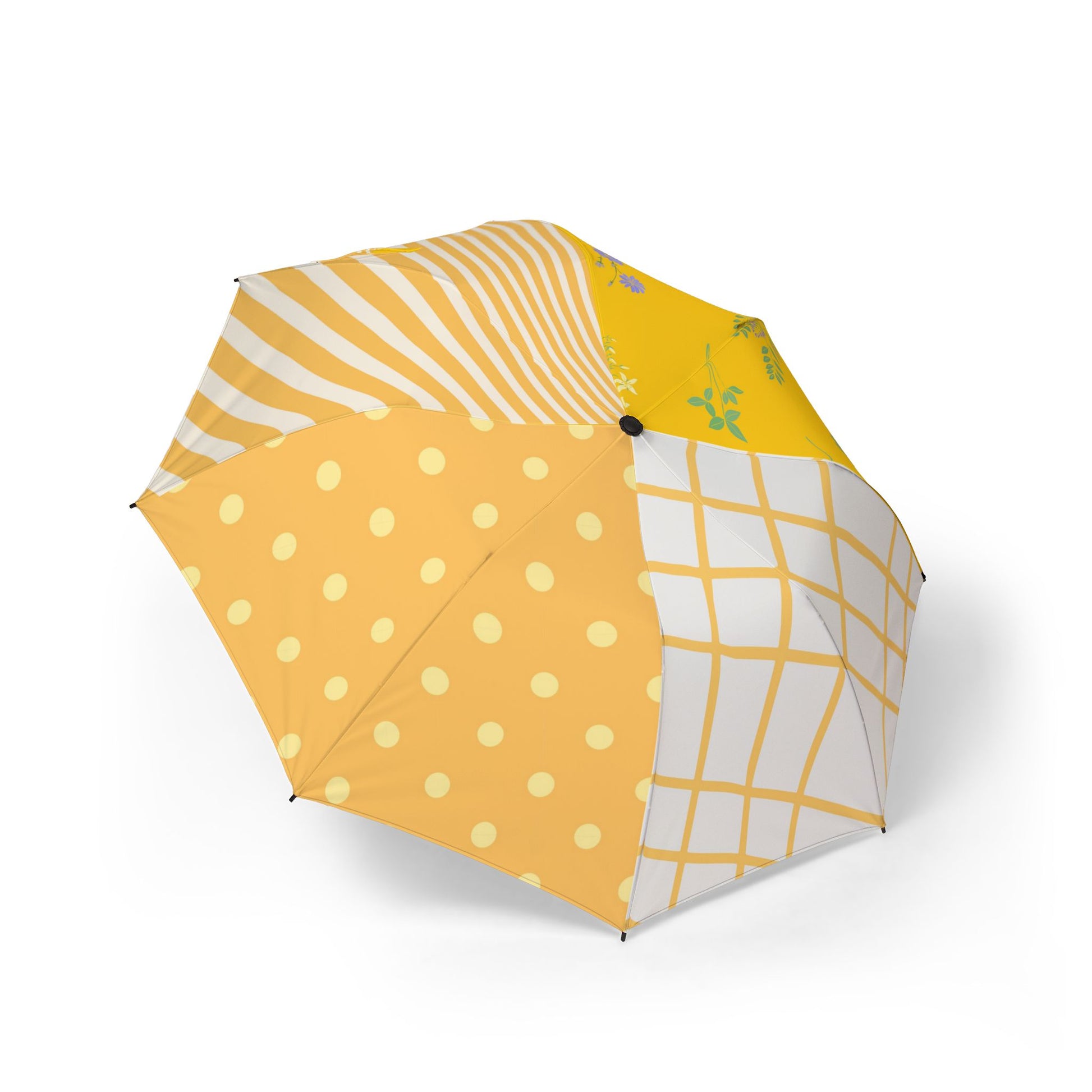 Colorful patchwork umbrella with polka dots, stripes, florals, and grid patterns in yellow tones.
