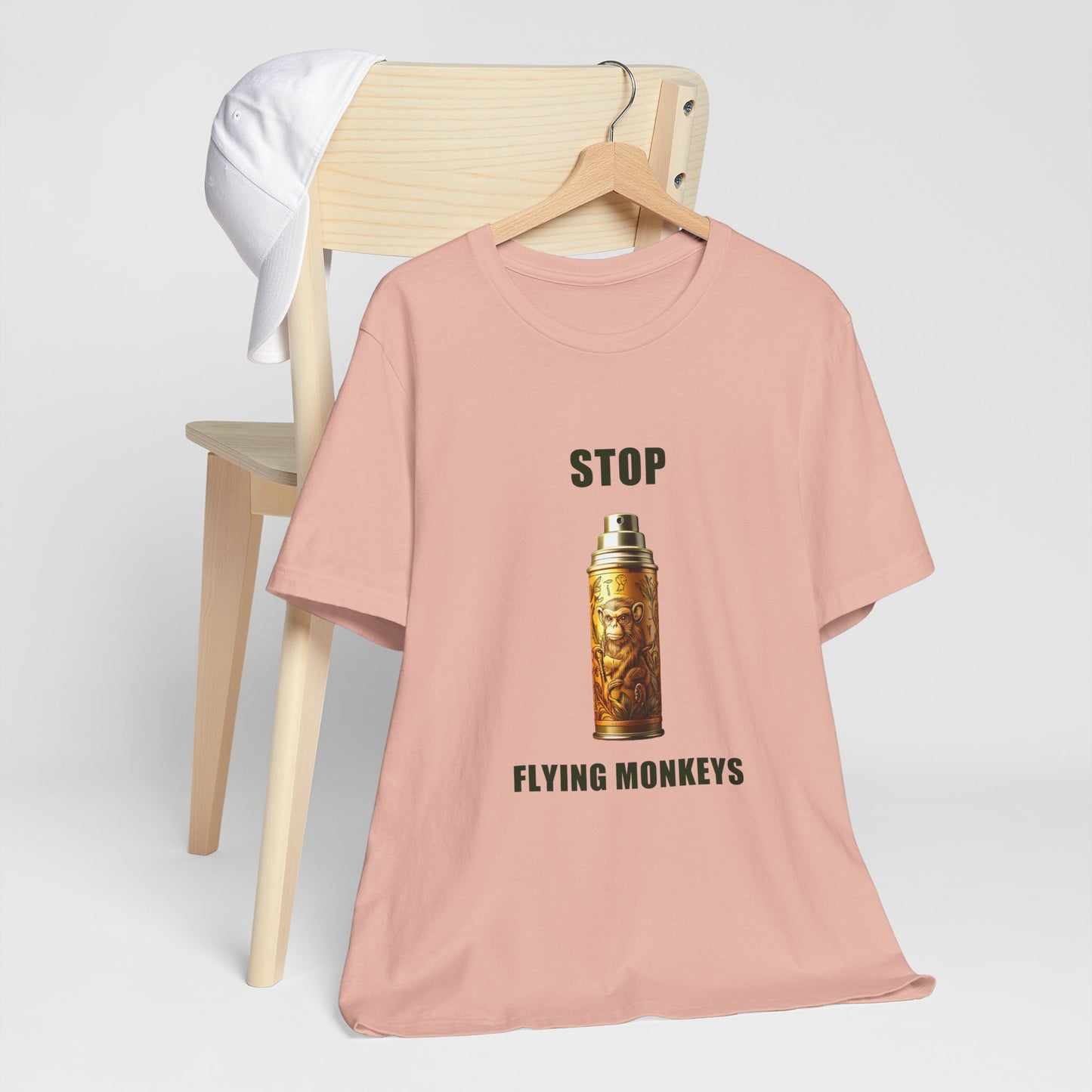 Peach Stop Flying Monkeys T-Shirt Alternate Version folded on chair mockup