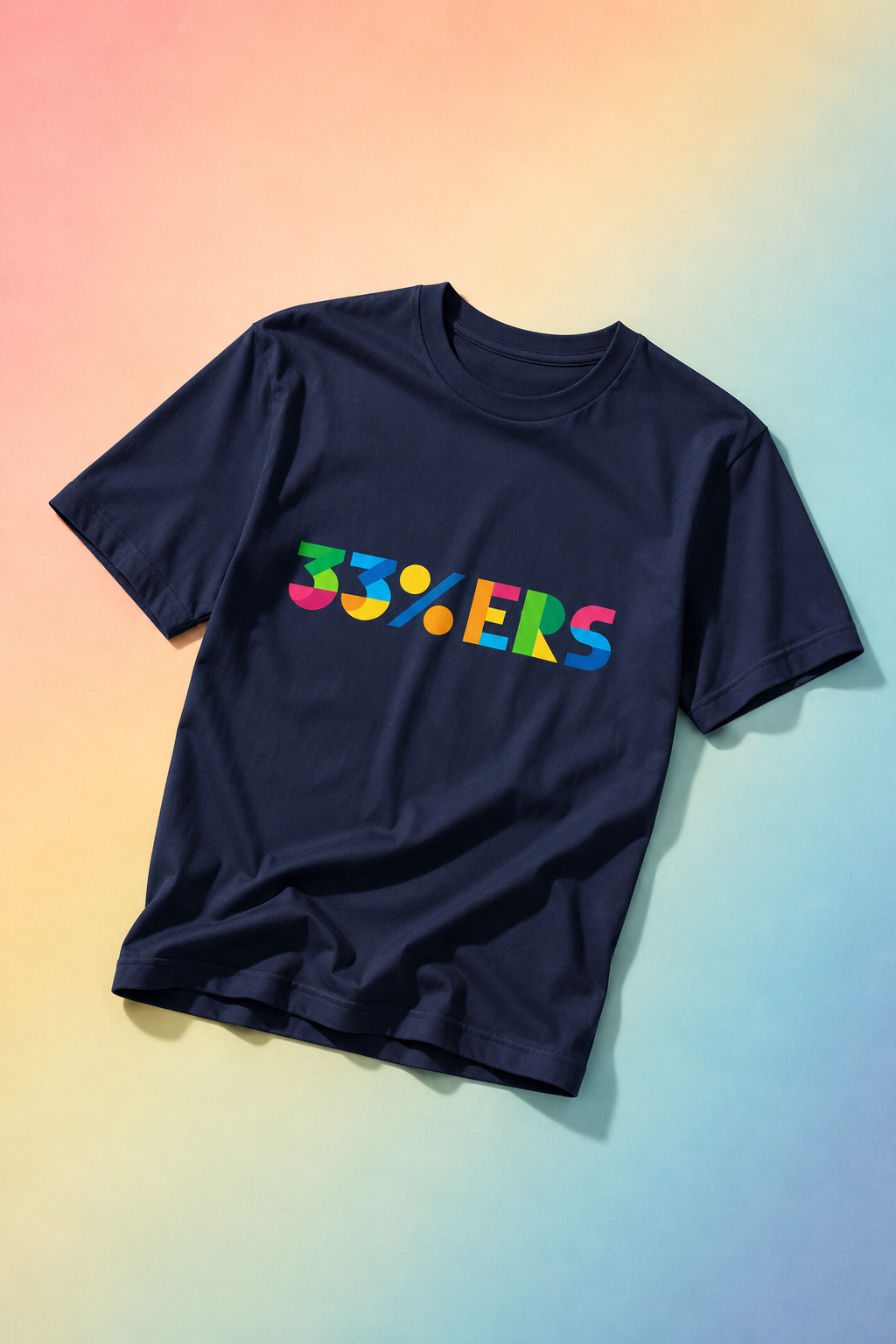 Navy 33%ERS graphic t-shirt flat lay on soft pastel gradient background.
