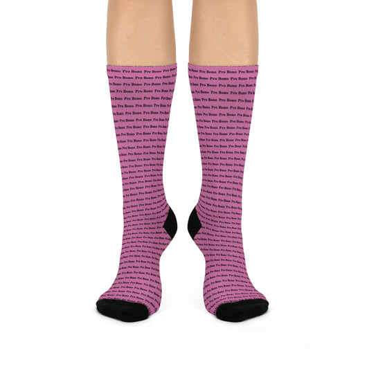 Person wearing pink crew socks with repeating “Pro Bono” text.