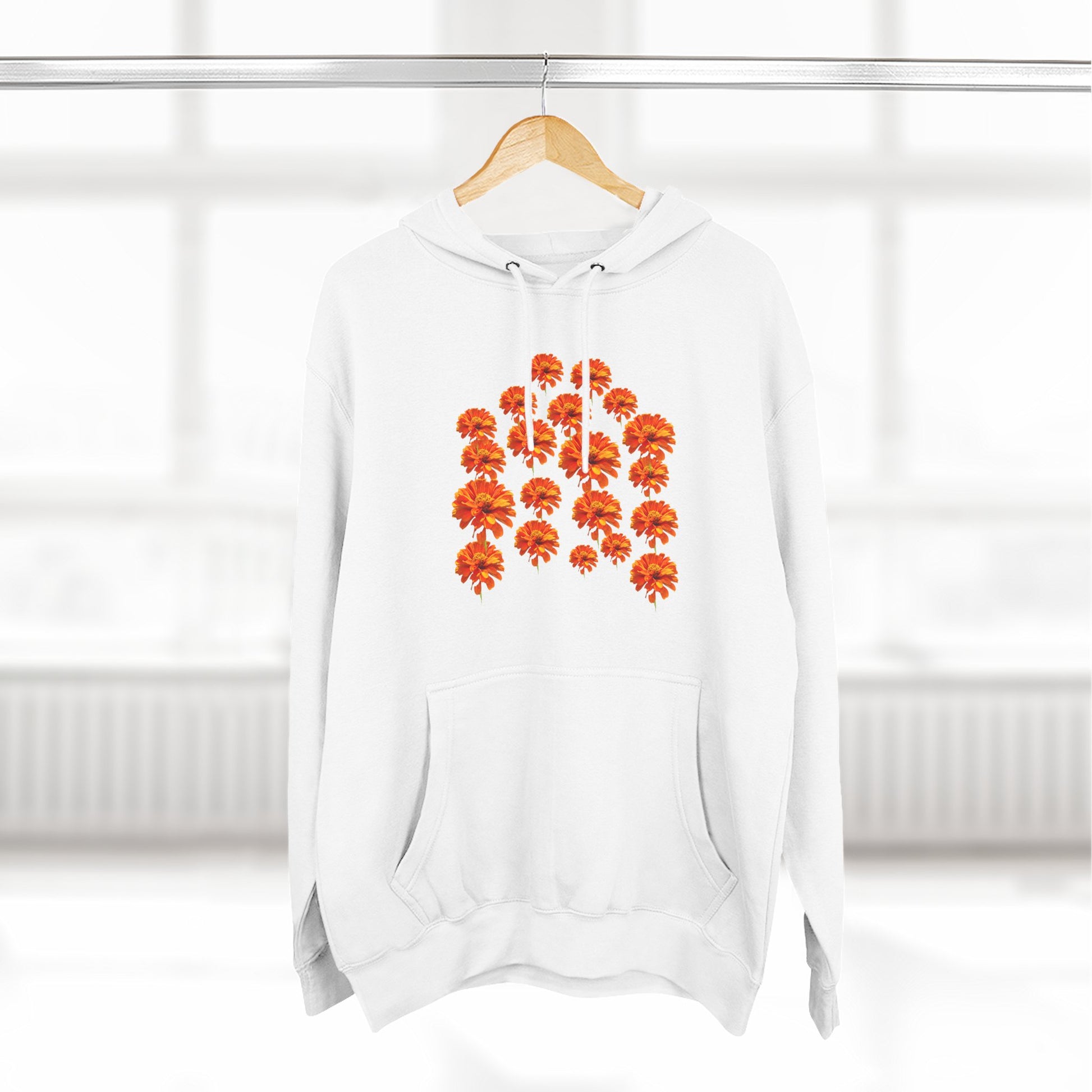White Zinnia Hoodie on a hanger with orange flower design