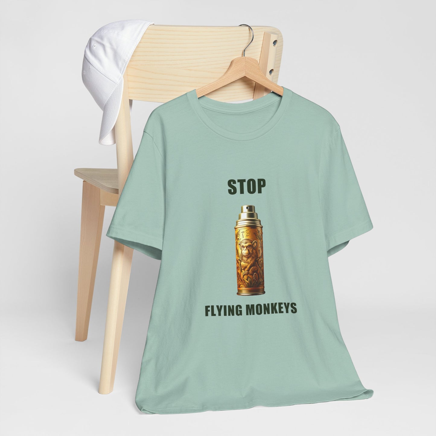 Green Stop Flying Monkeys T-Shirt Alternate Version folded on chair mockup