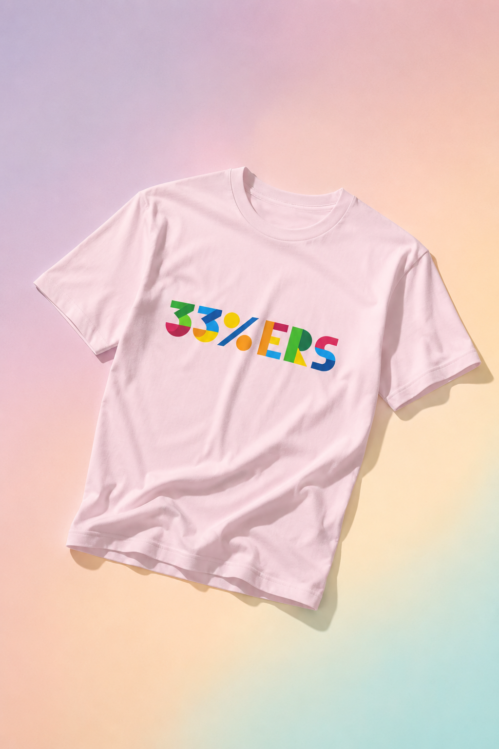 Pink 33%ERS graphic t-shirt flat lay on pastel gradient background.