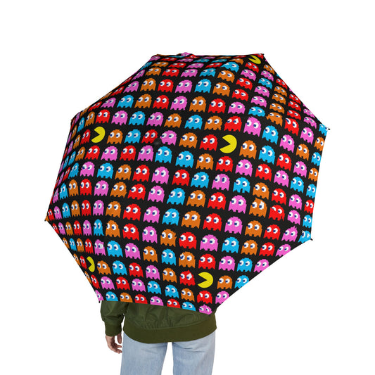 Person holding a Pac-Man themed semi-automatic umbrella featuring colorful ghosts and retro arcade patterns made of 100% polyester

