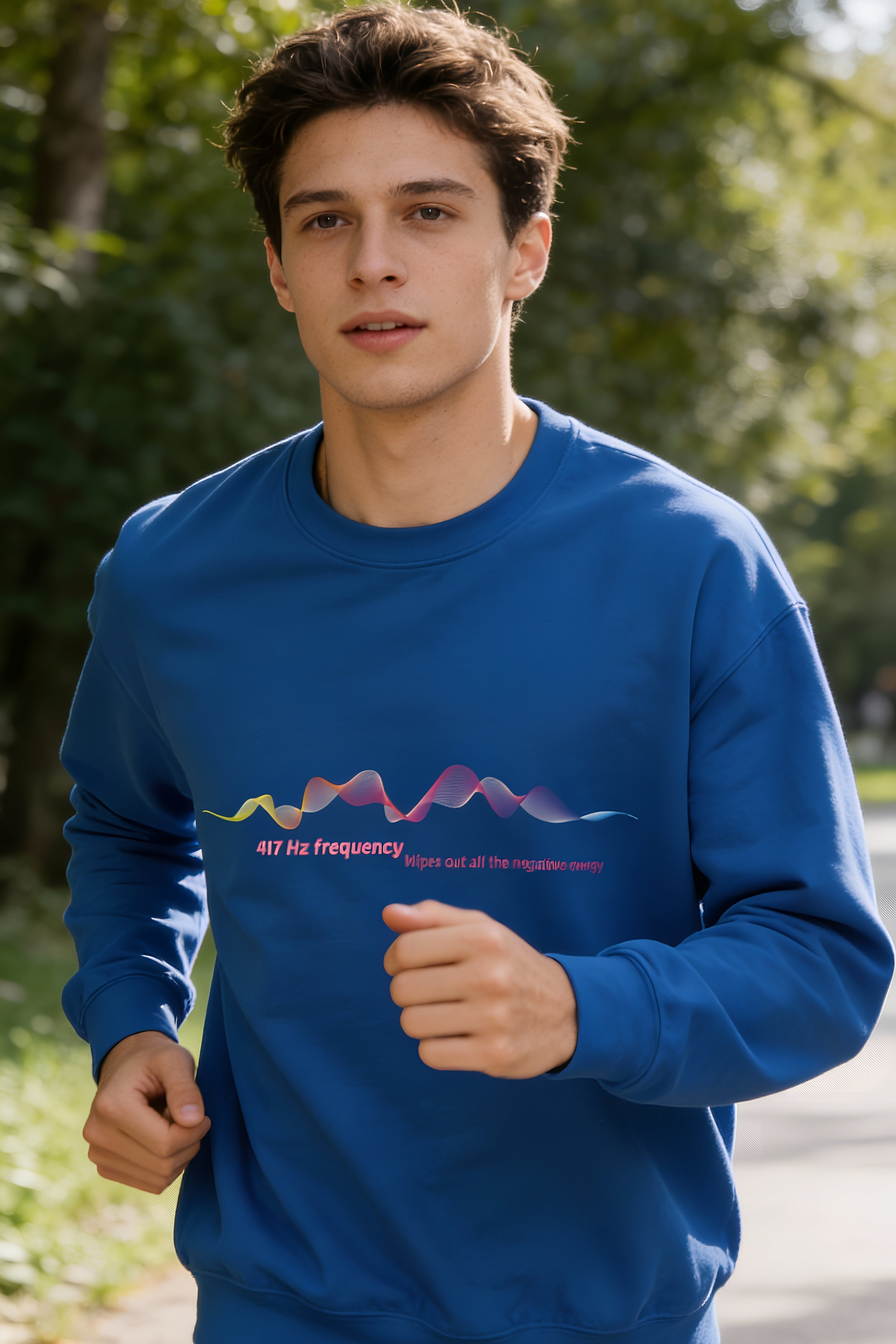 Male model jogging outdoors wearing blue 417 Hz frequency graphic sweatshirt