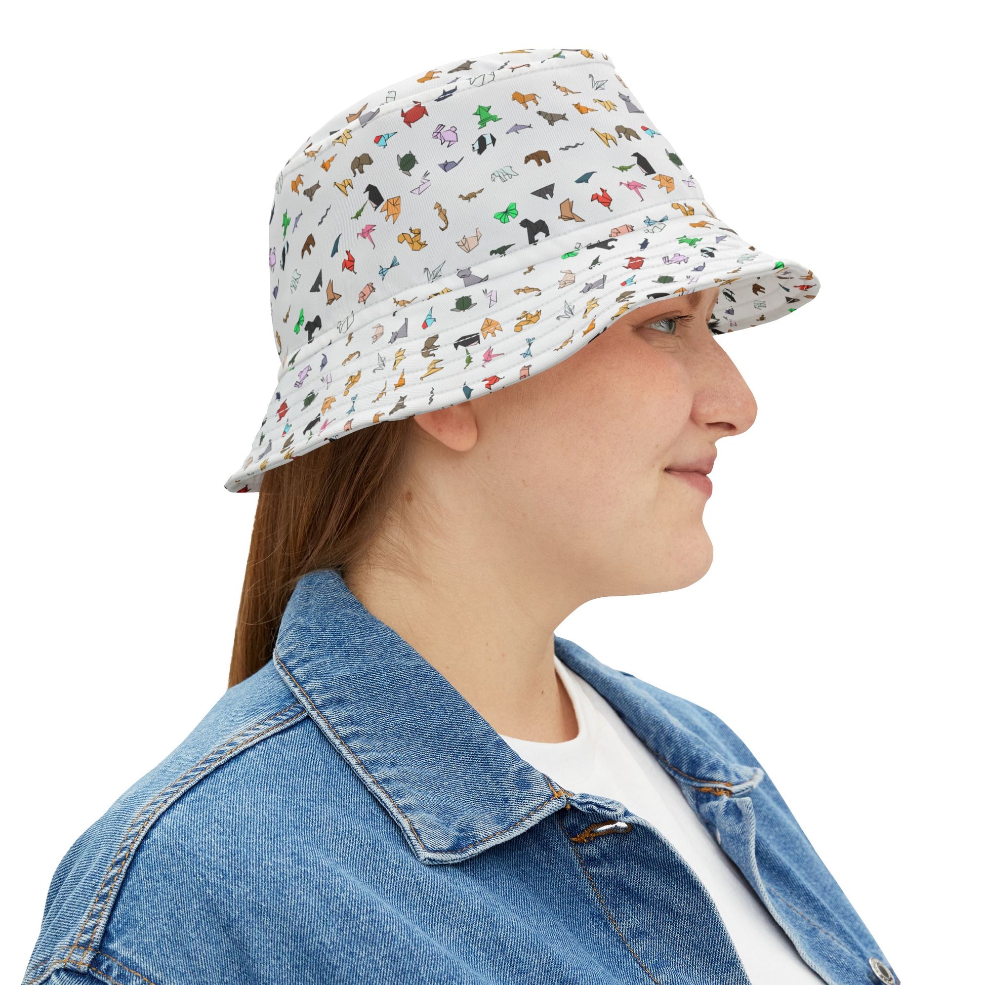 Side profile of woman wearing patterned bucket hat with colorful origami animal pattern