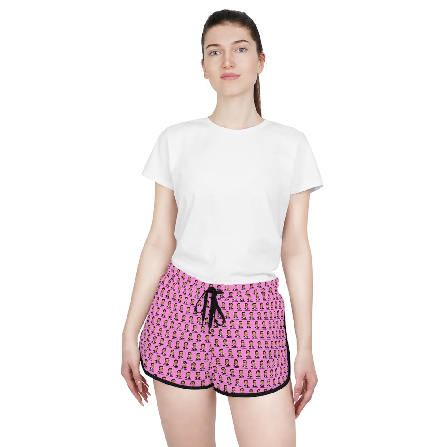 Female model wearing pink Gavin Newsom political cartoon lounge shorts with white t-shirt
