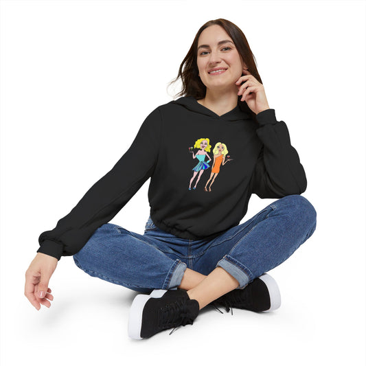 Woman sitting cross-legged in black waitress hand-drawn hoodie, smiling.