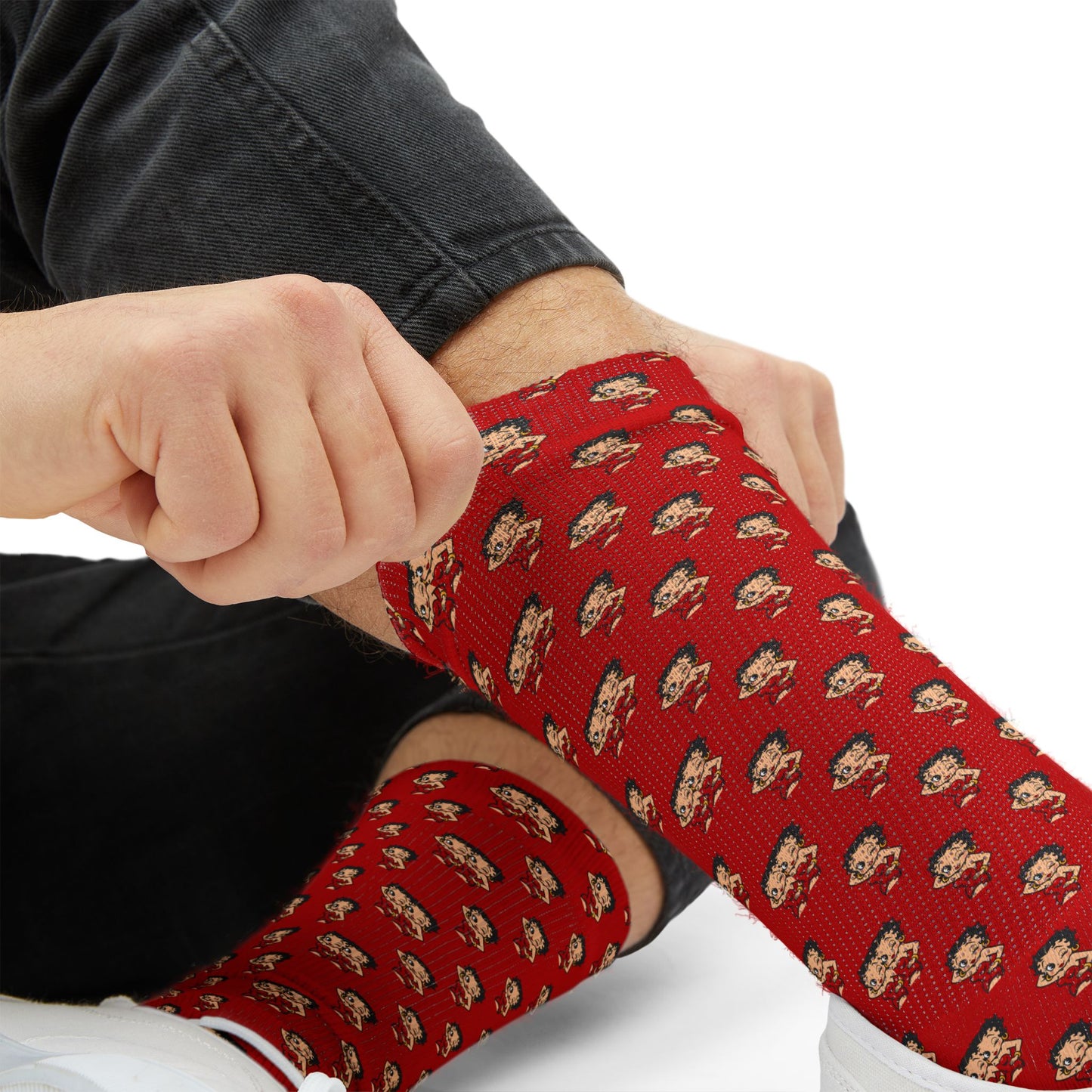 Close-up of red Betty Boop crew socks being stretched to show soft fabric and detailed print