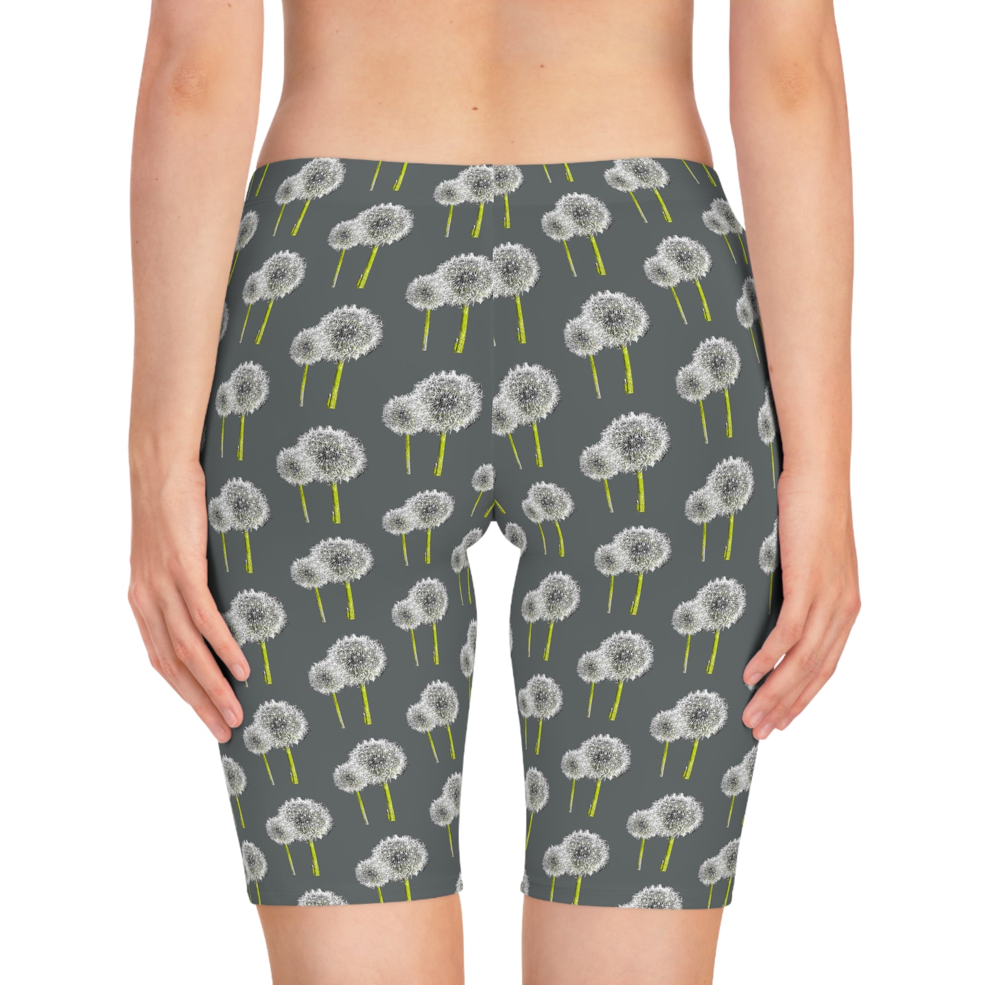Back view of woman wearing Dandelion Women’s Bike Shorts with gray base and white dandelion print