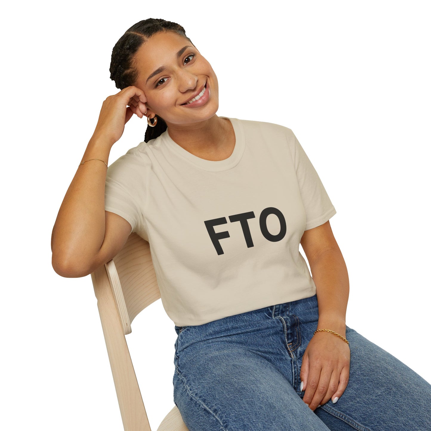 Woman sitting smiling in beige FTO T-shirt