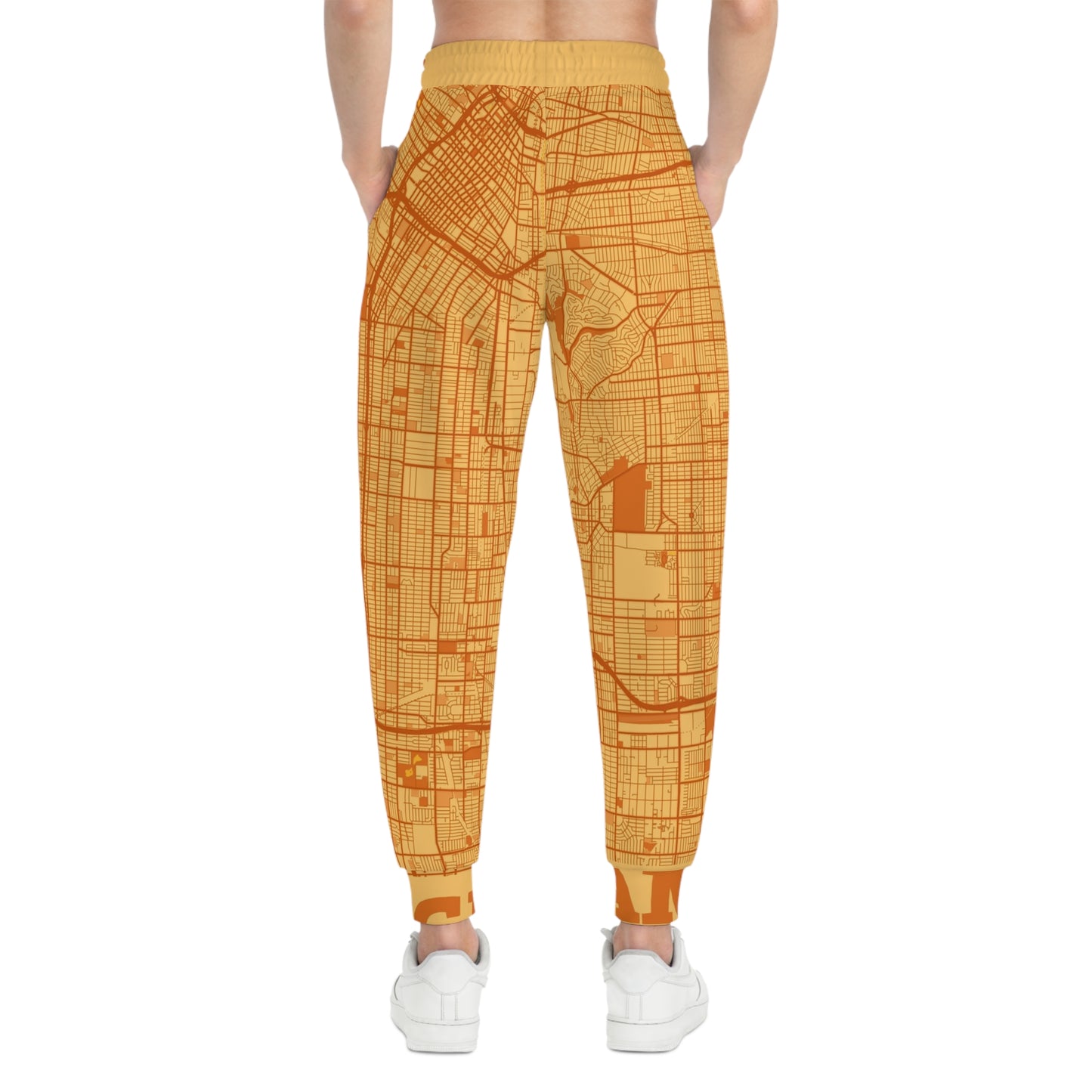 Back view of orange Los Angeles map print joggers on white background showcasing full pattern layout.