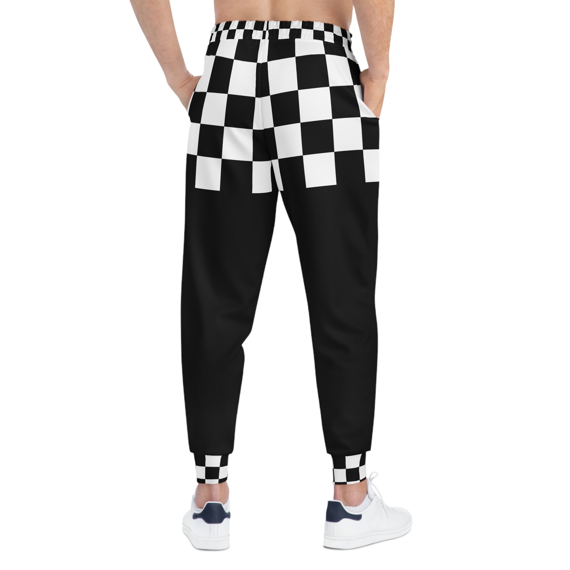 Black and white checkered pants worn by a person on a white background