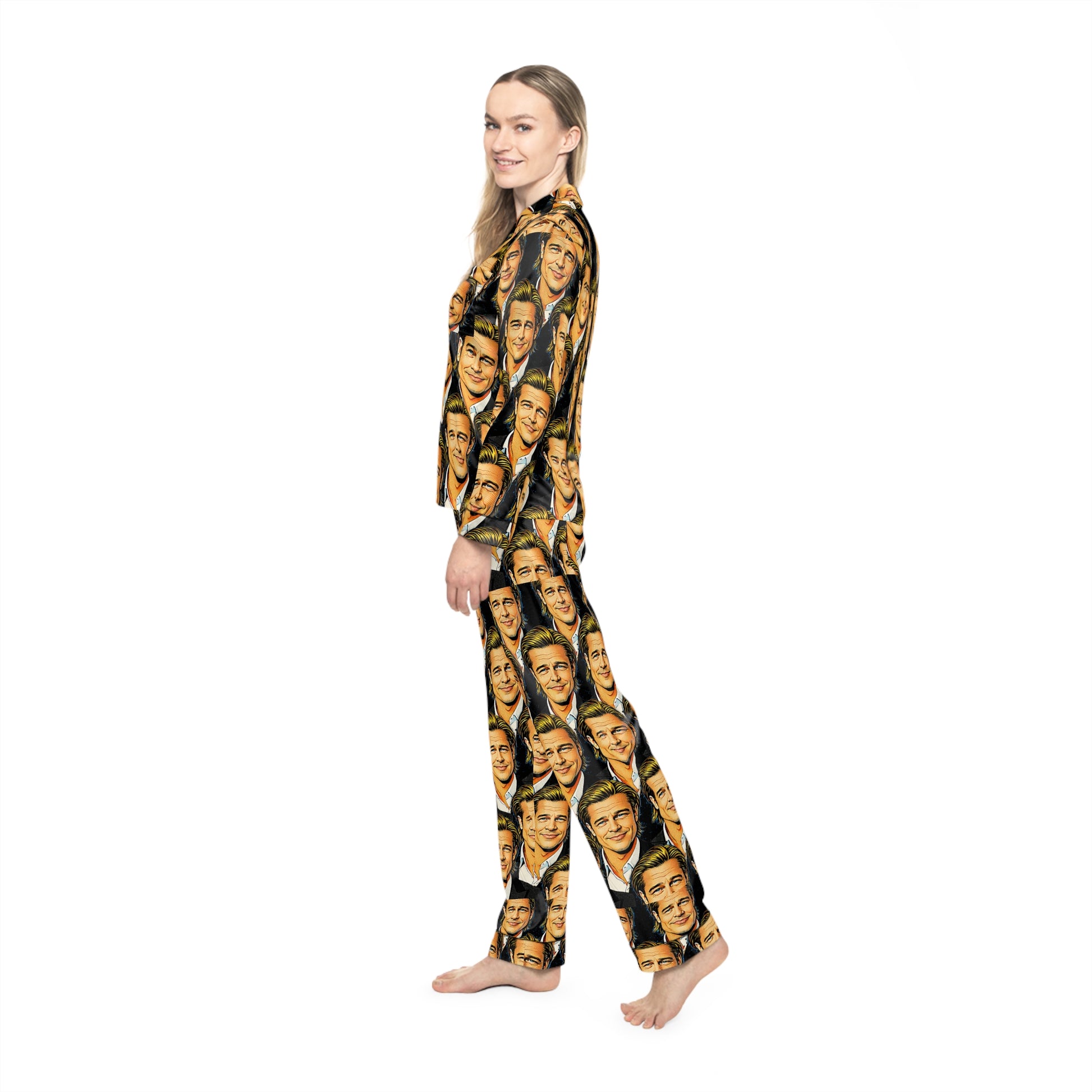 Side profile of woman wearing graphic face print satin pajamas showing button front top and relaxed silhouette.