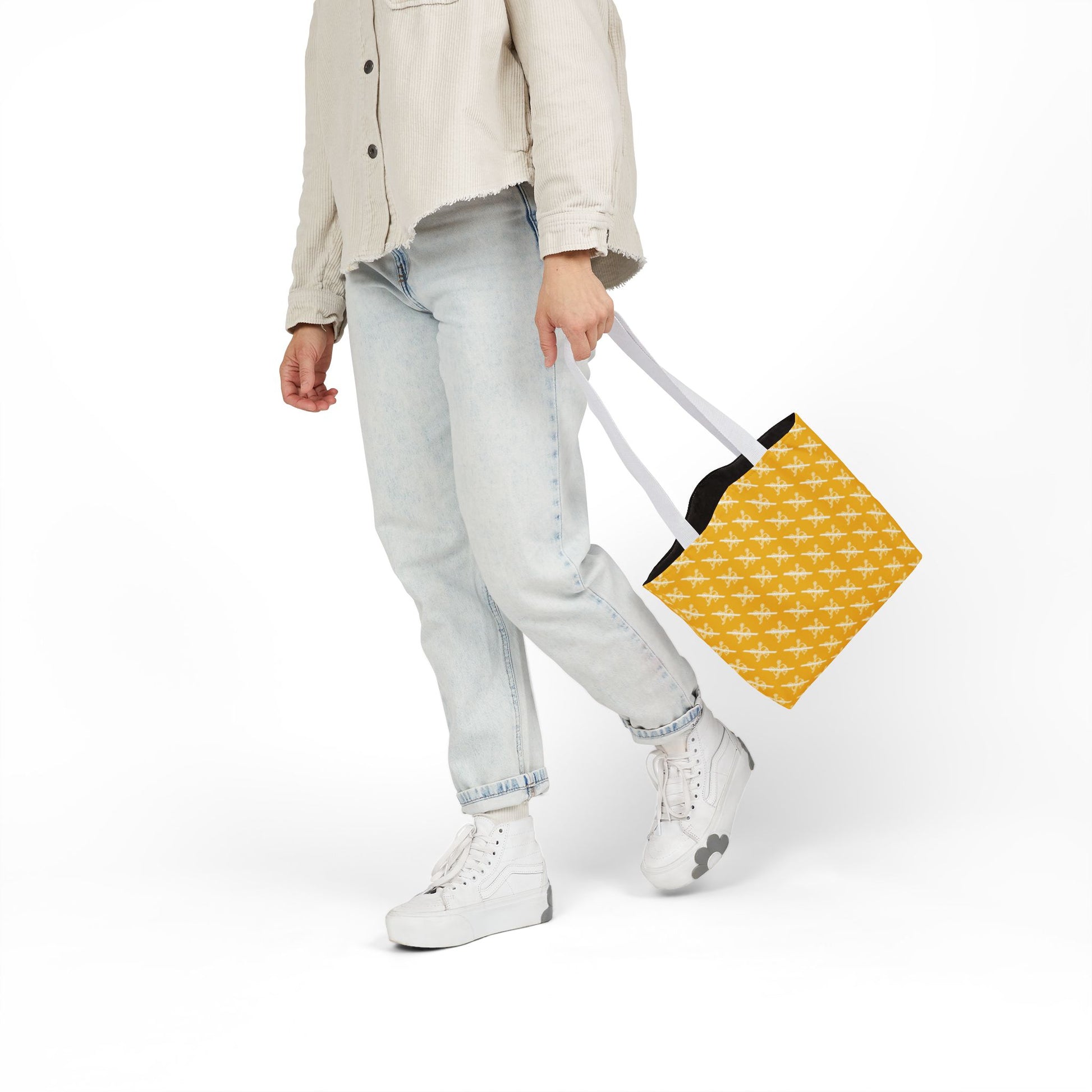 Proudly Childless yellow tote bag with white handles carried at side by model in casual outfit