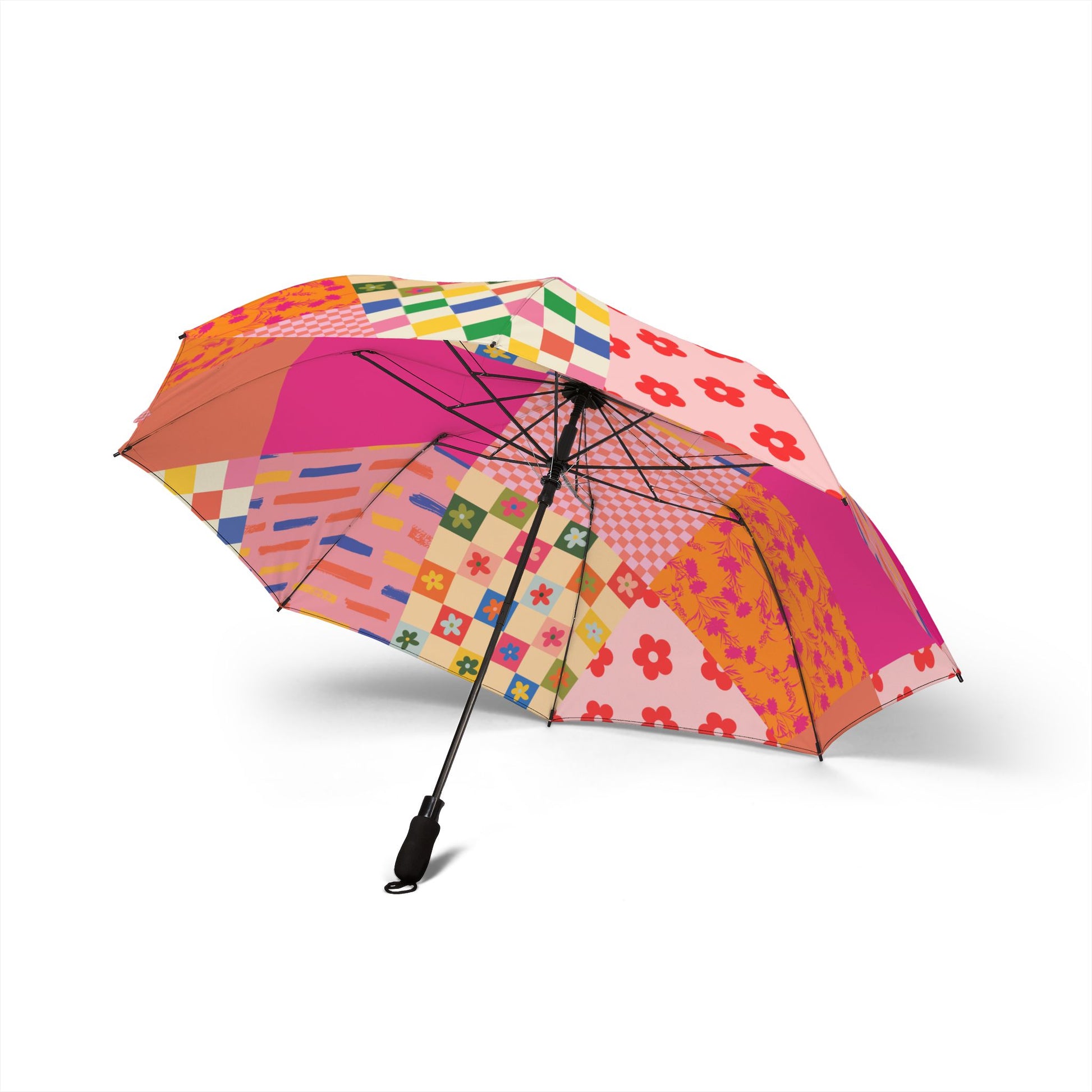 Side of a pink patchwork-style semi-automatic umbrella with floral and checkered quilt-inspired patterns