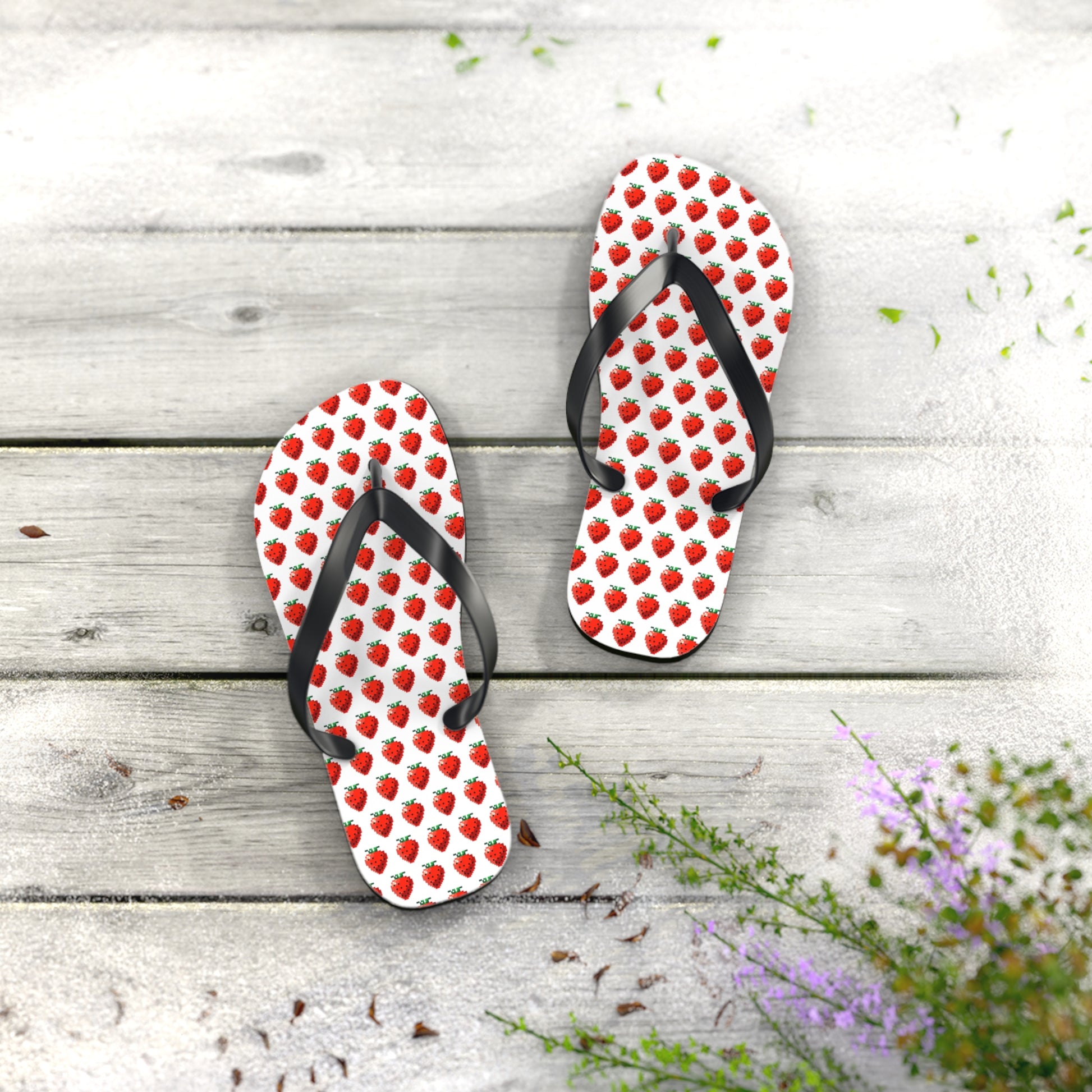 Pair of strawberry pixel art flip flops on wooden background summer styling