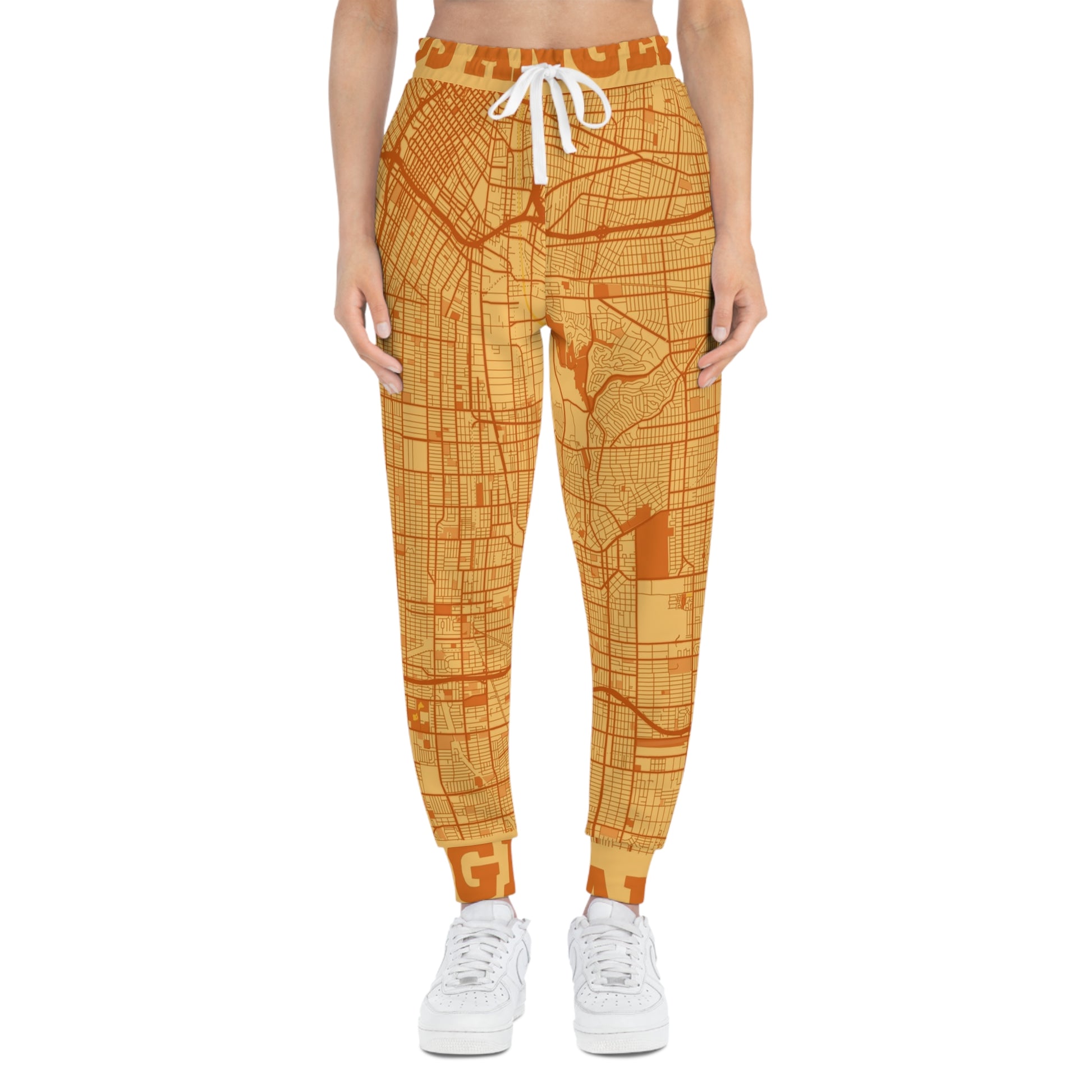 Front view of orange Los Angeles map print joggers on a model against a white background.