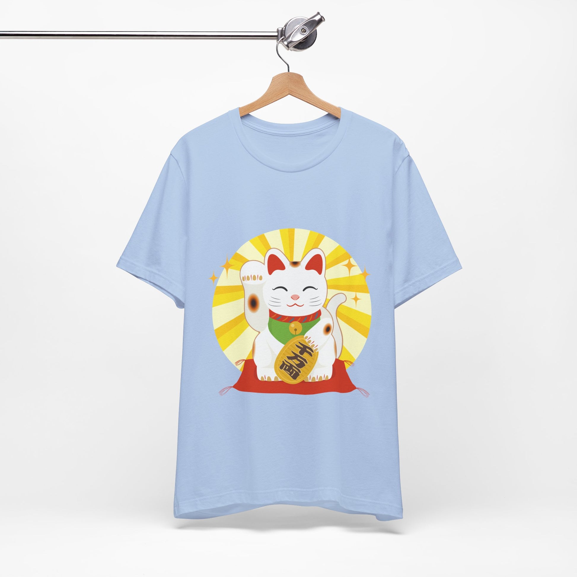 Light blue t-shirt with a beckoning cat design on a hanger against a white background