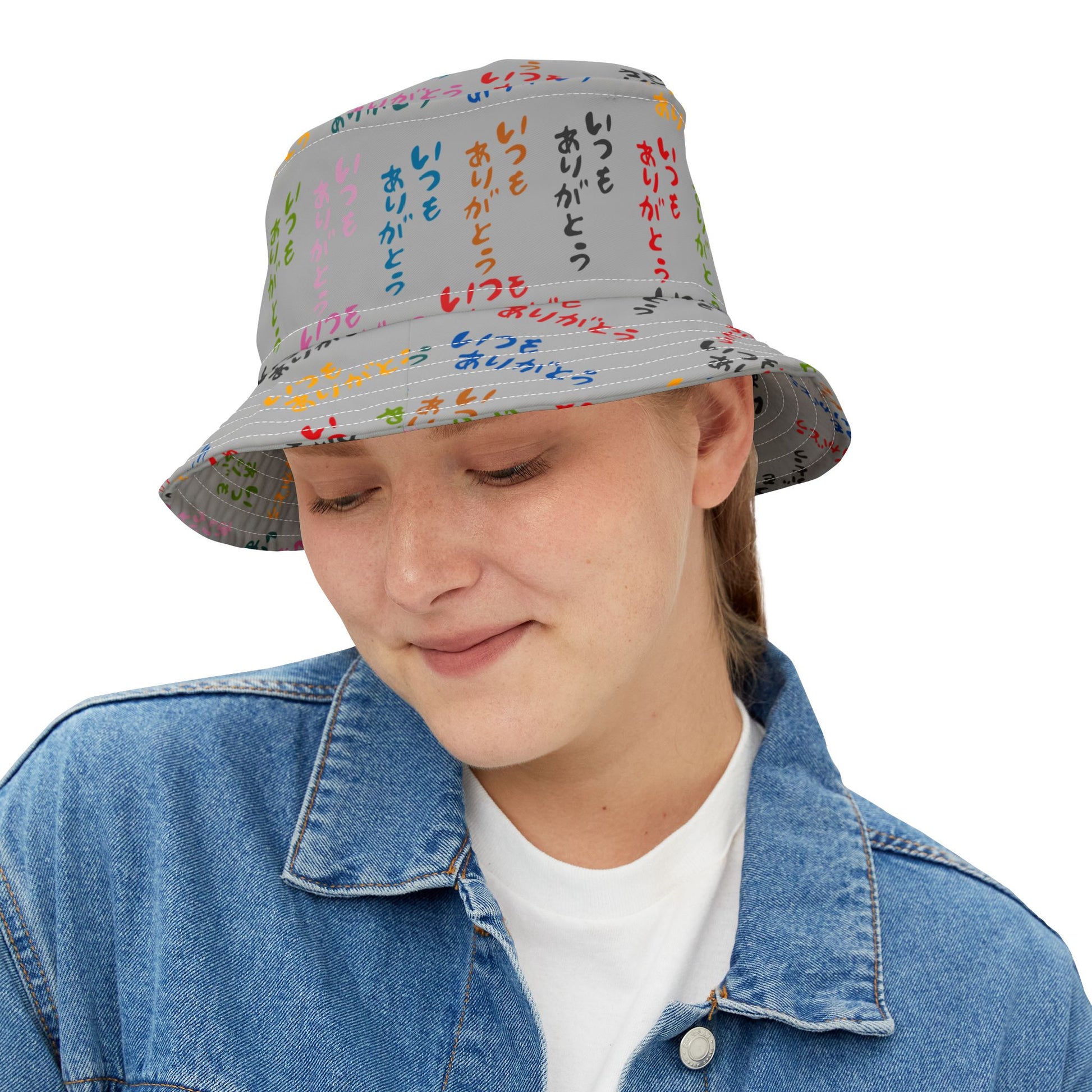Woman wearing Japanese Text Bucket Hat, looking down and smiling.