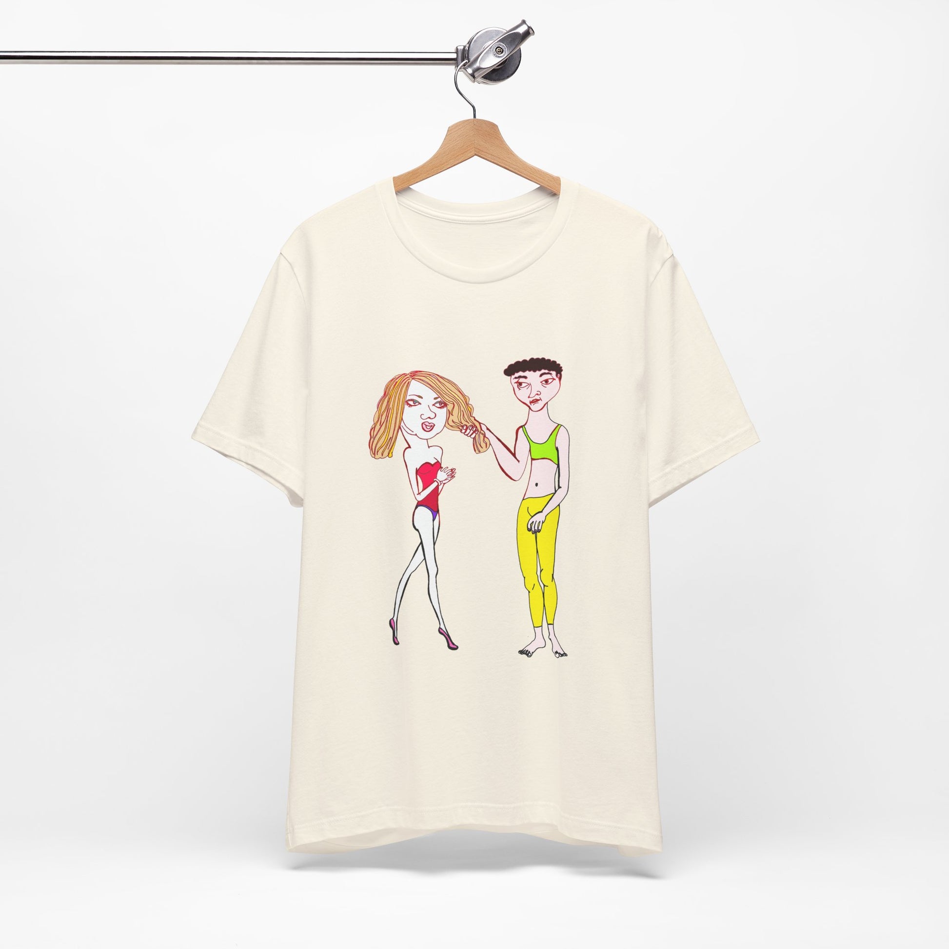 Cream Charlotte and Van hand-drawn couple tee hanging on a wooden hanger against a white wall.
