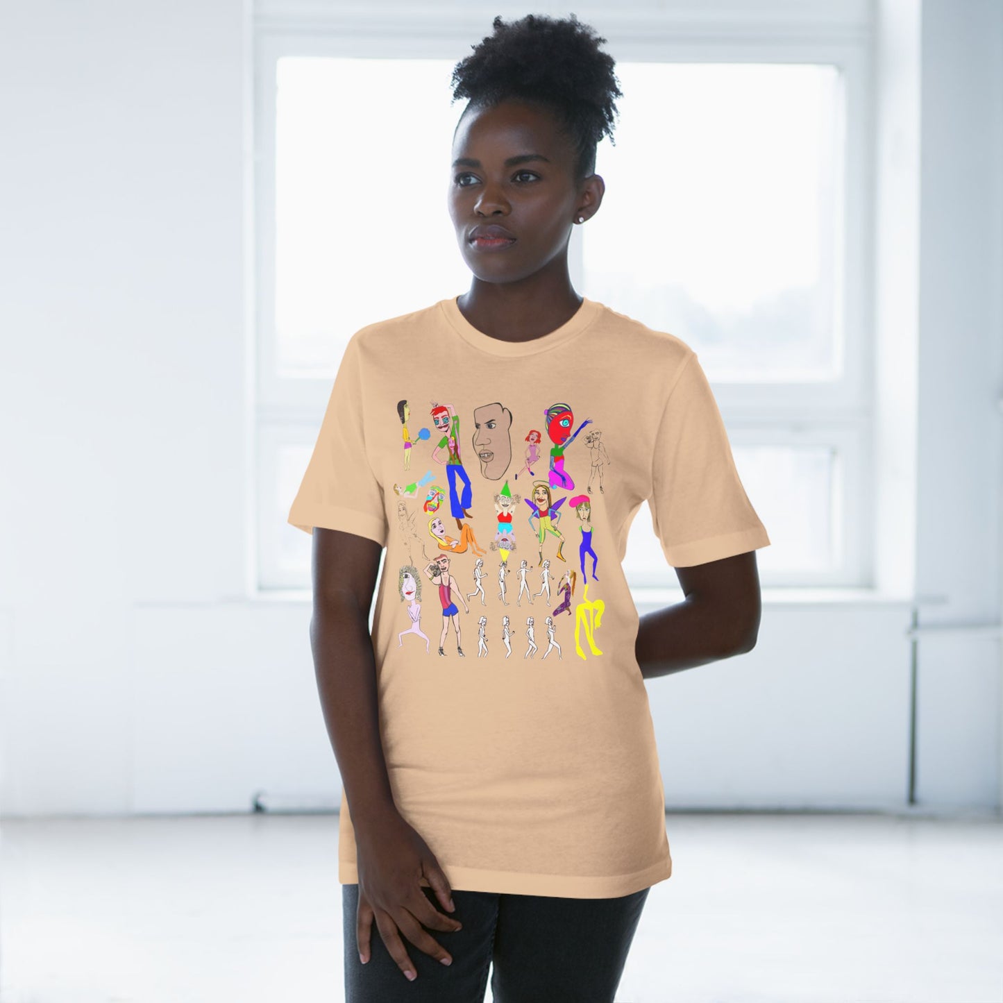 Female model wearing beige Mix Unisex Deluxe T-Shirt with colorful hand drawn design.