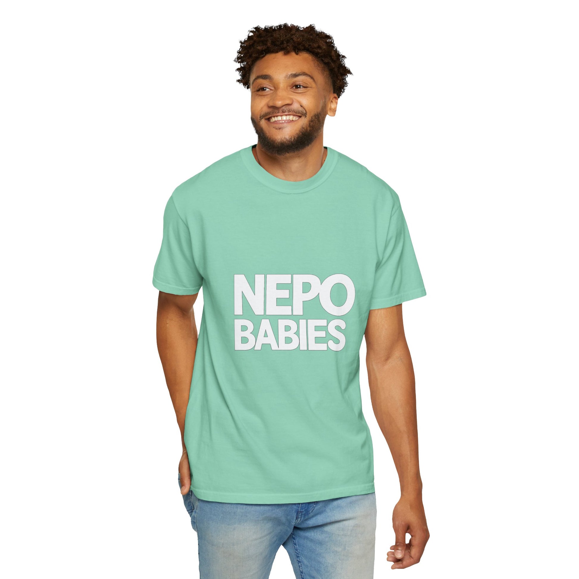Man wearing a light green t-shirt with 'NEPO BABIES' text on a white background