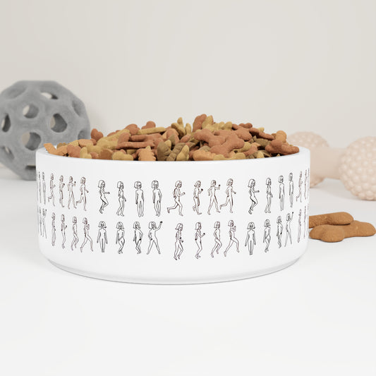White ceramic Running Out Pet Bowl filled with dog treats, placed beside dog toys.