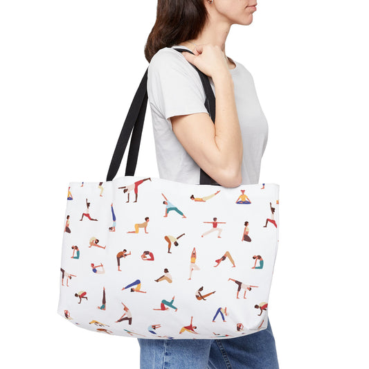 Person holding a tote bag with yoga pose illustrations on a white background