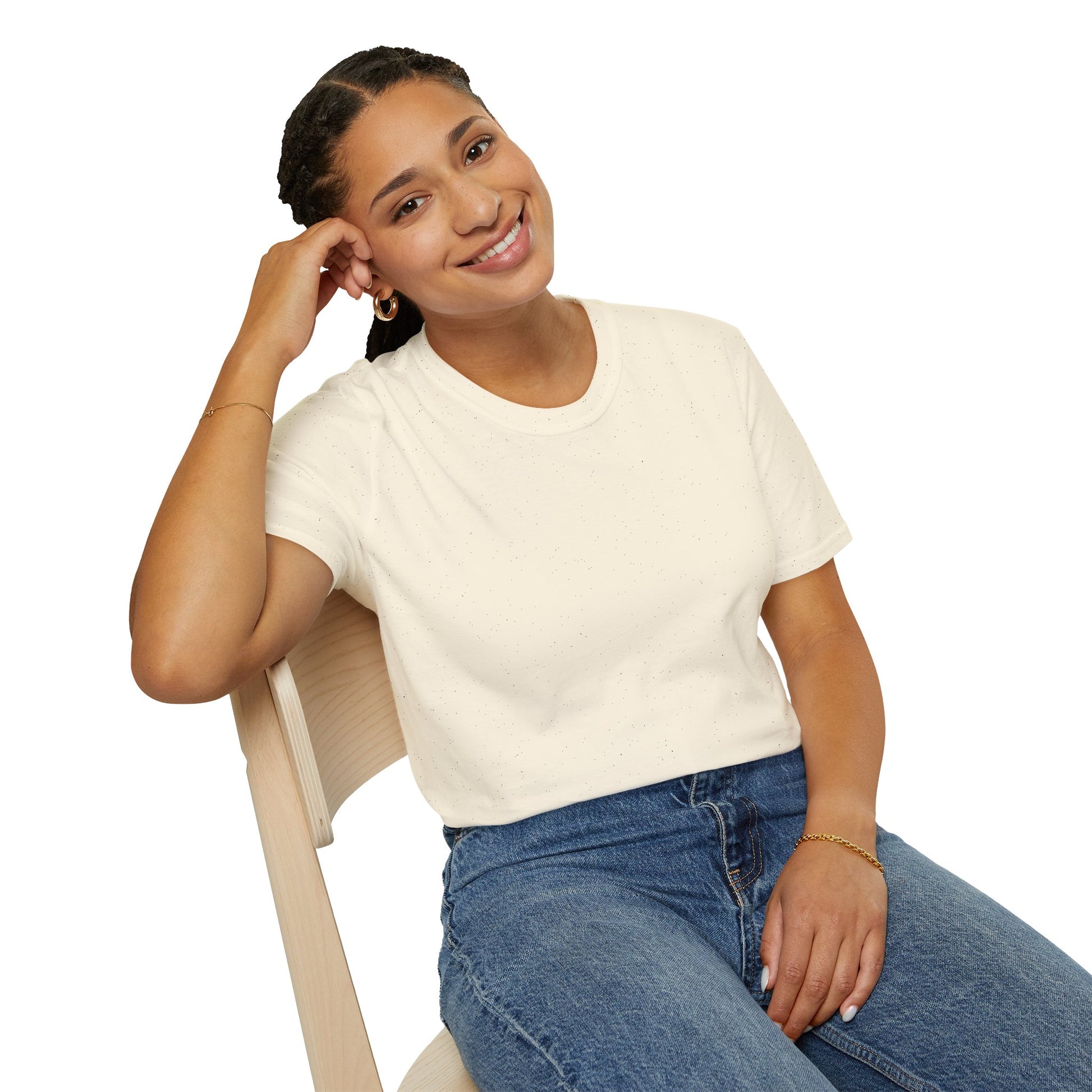 Woman sitting in cream t-shirt smiling casually, showing front view without design visible