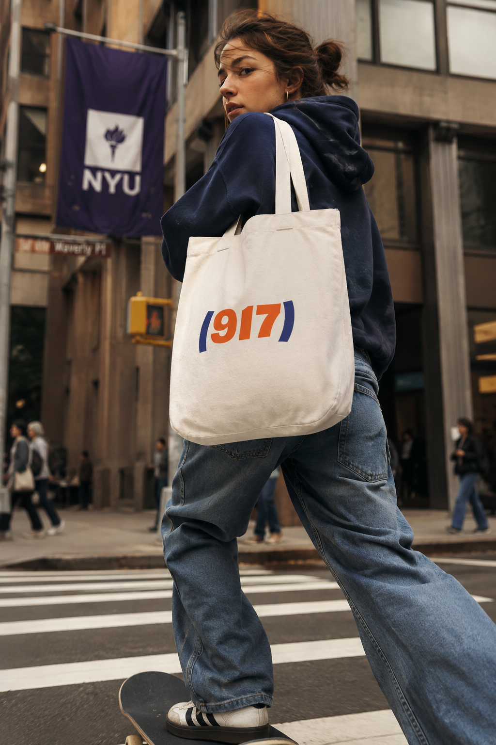 Gen Z woman skateboarding to college in New York City while carrying a 917 NYC canvas tote bag.