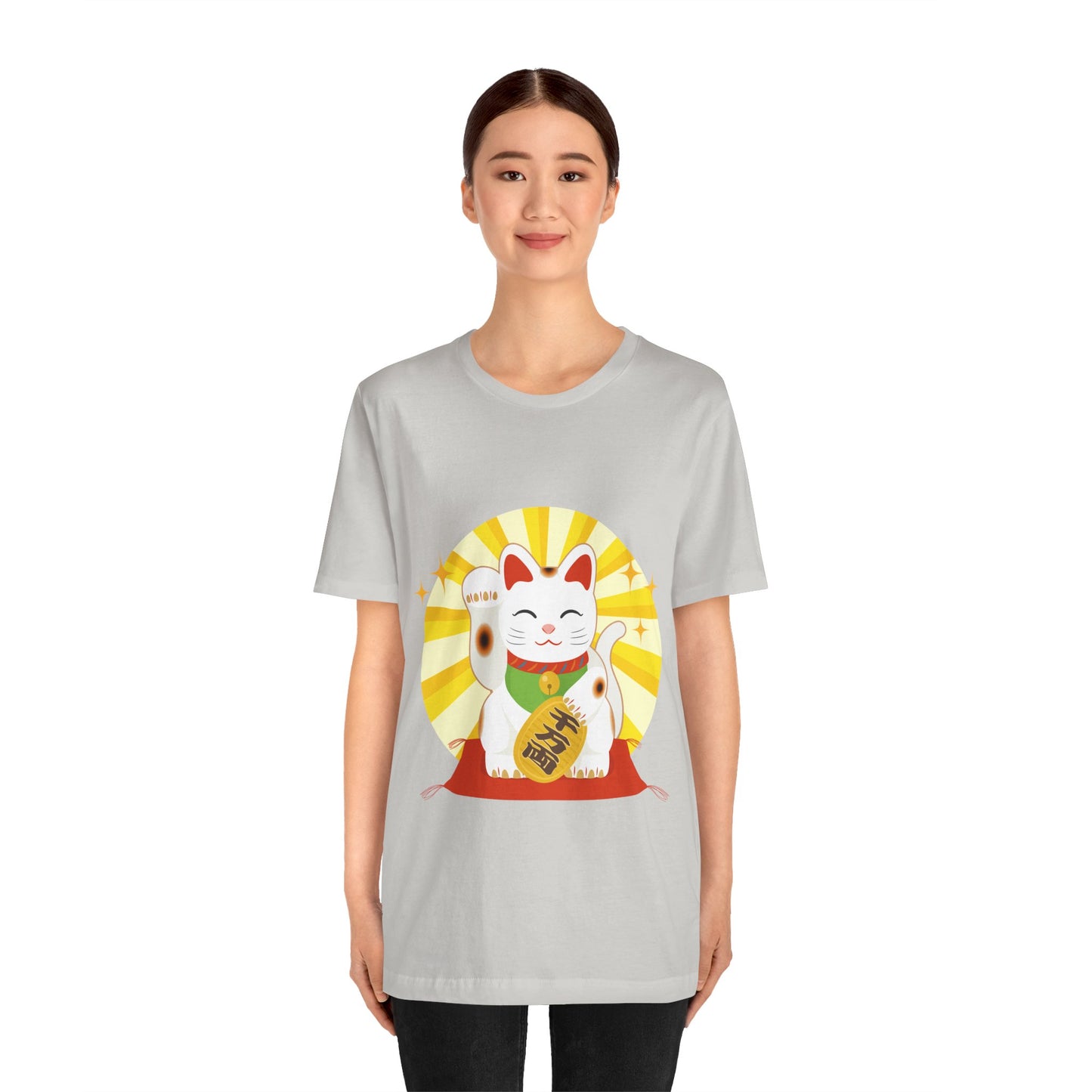 Person wearing a gray t-shirt with a lucky cat graphic on a white background
