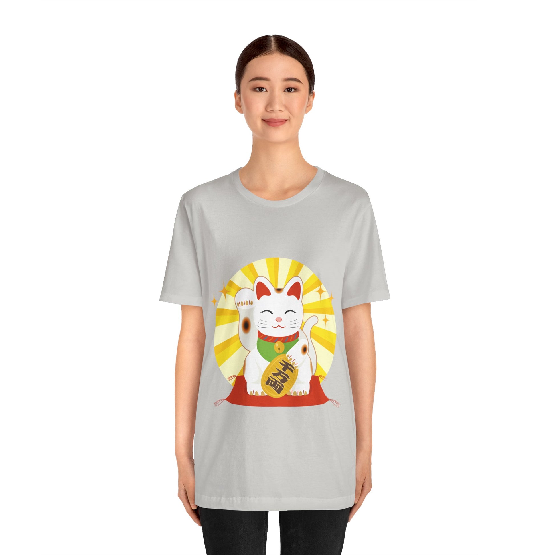 Person wearing a gray t-shirt with a lucky cat graphic on a white background