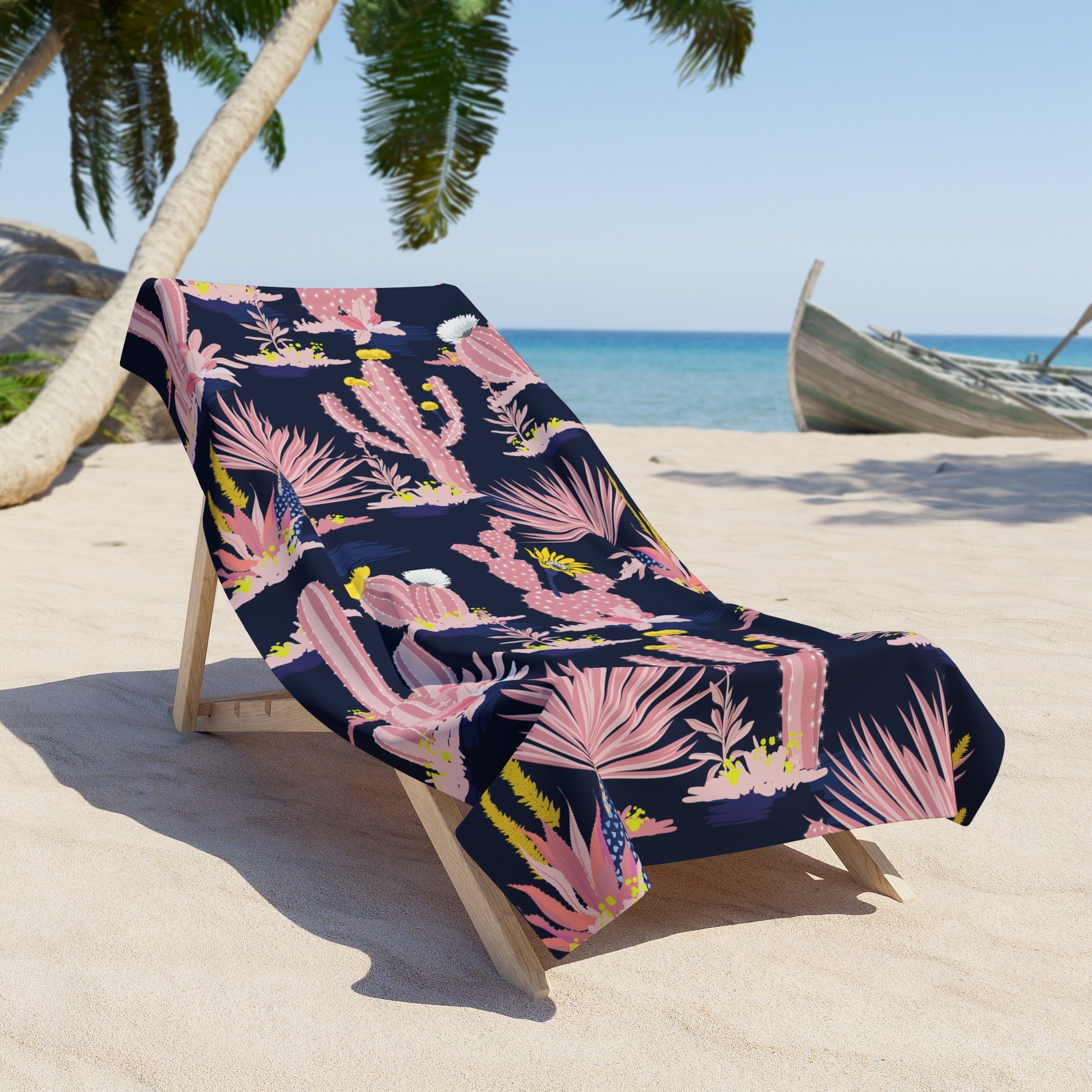 Beach chair with pink cactus patterned towel on sunny tropical beach with palm trees and blue ocean in background