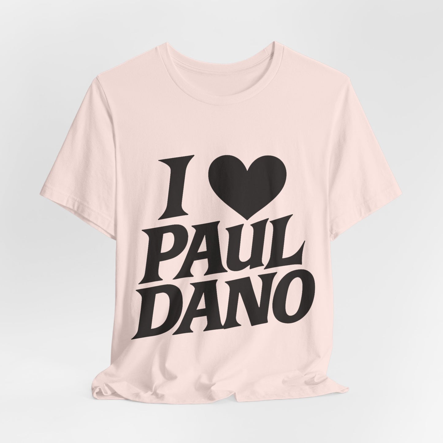 Pink t-shirt with 'I ❤️ Paul Dano' text on a light gray background