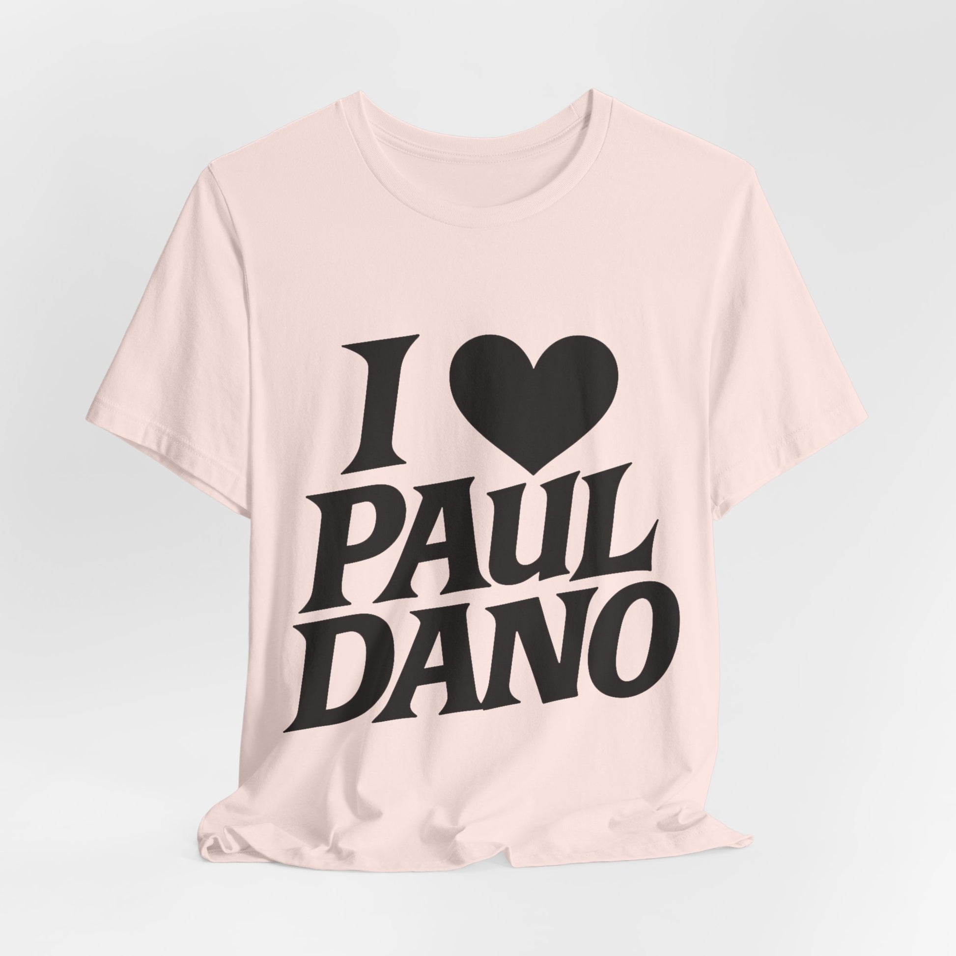 Pink t-shirt with 'I ❤️ Paul Dano' text on a light gray background
