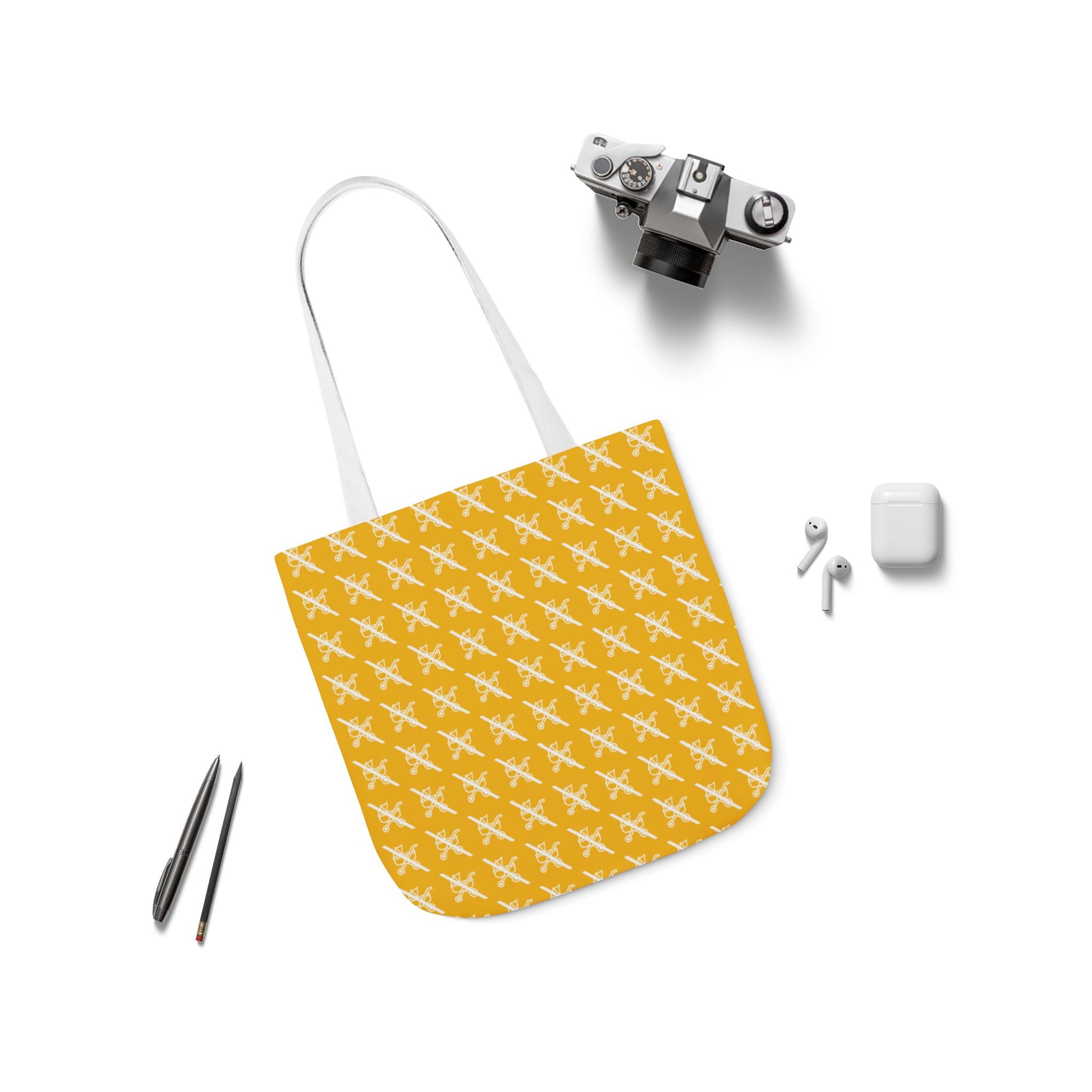 Flat lay of Proudly Childless yellow tote bag with white handles next to accessories on white background