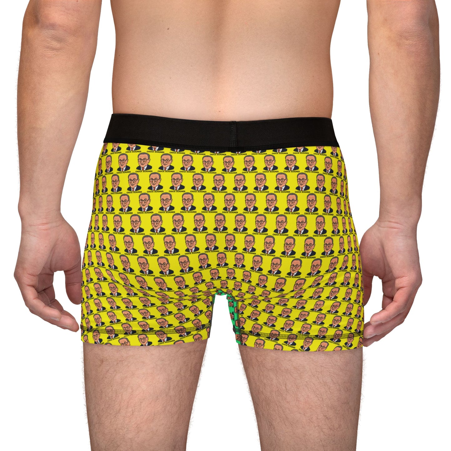 Back view of model wearing Chuck Schumer boxer briefs with all-over yellow face pattern and black waistband