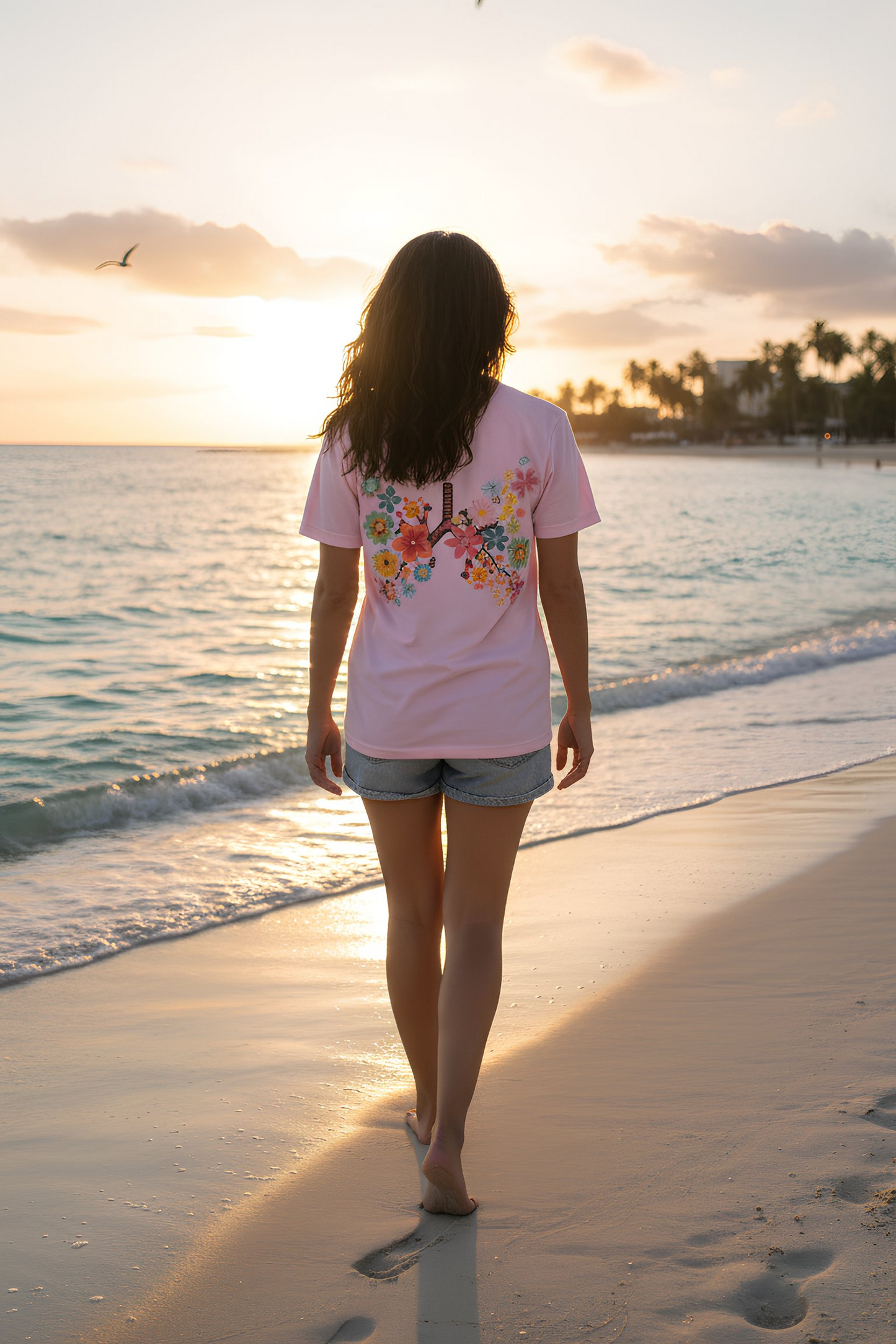 Breath T-Shirt white worn by female walking on the beach at sunset