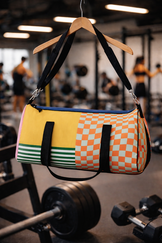 Urban Vibes Duffel Bag hanging from gym rack with colorful patchwork design