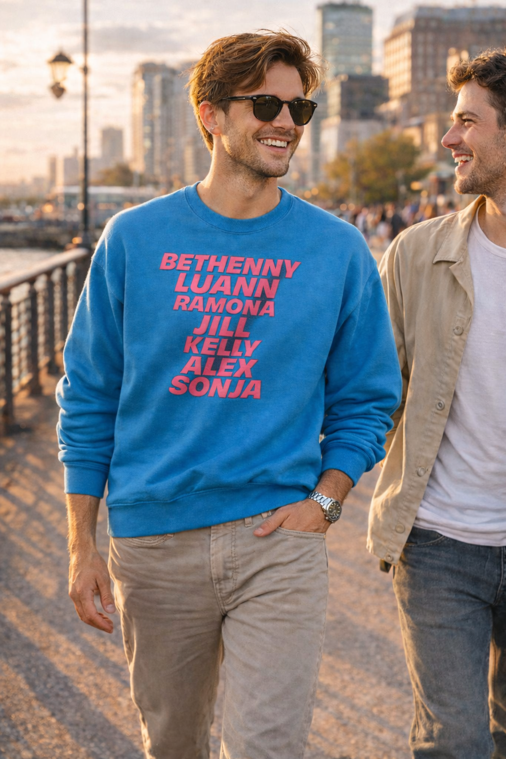 Lifestyle photo of man wearing blue OG NY Housewives sweatshirt outdoors