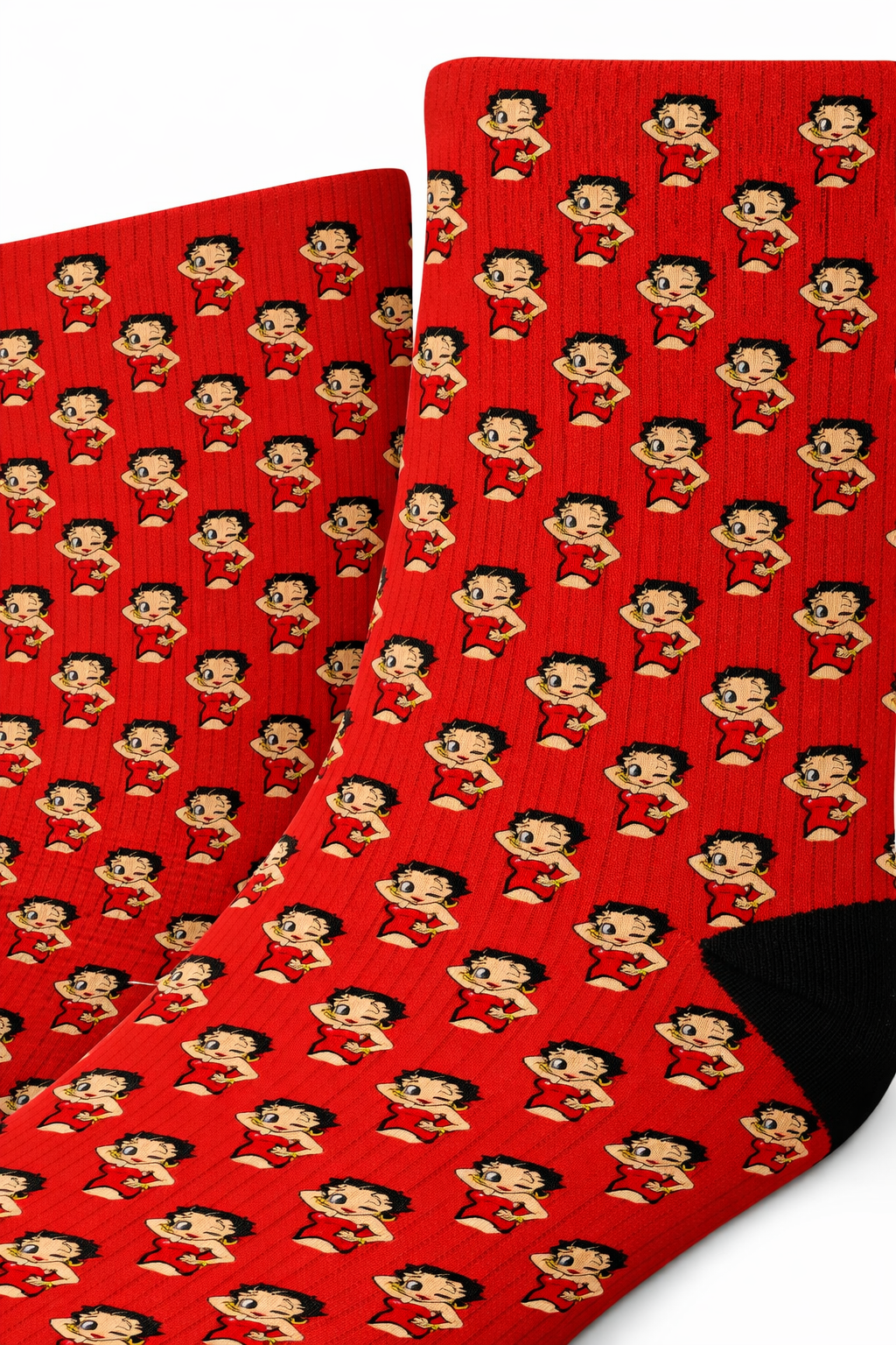 Close-up of red Betty Boop pattern crew socks showing small repeating cartoon figures on ribbed fabric with black heel and toe details