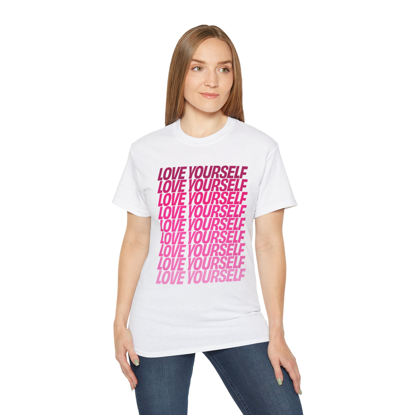 Model wearing Love Yourself T-Shirt in White with pink graphic, front view
