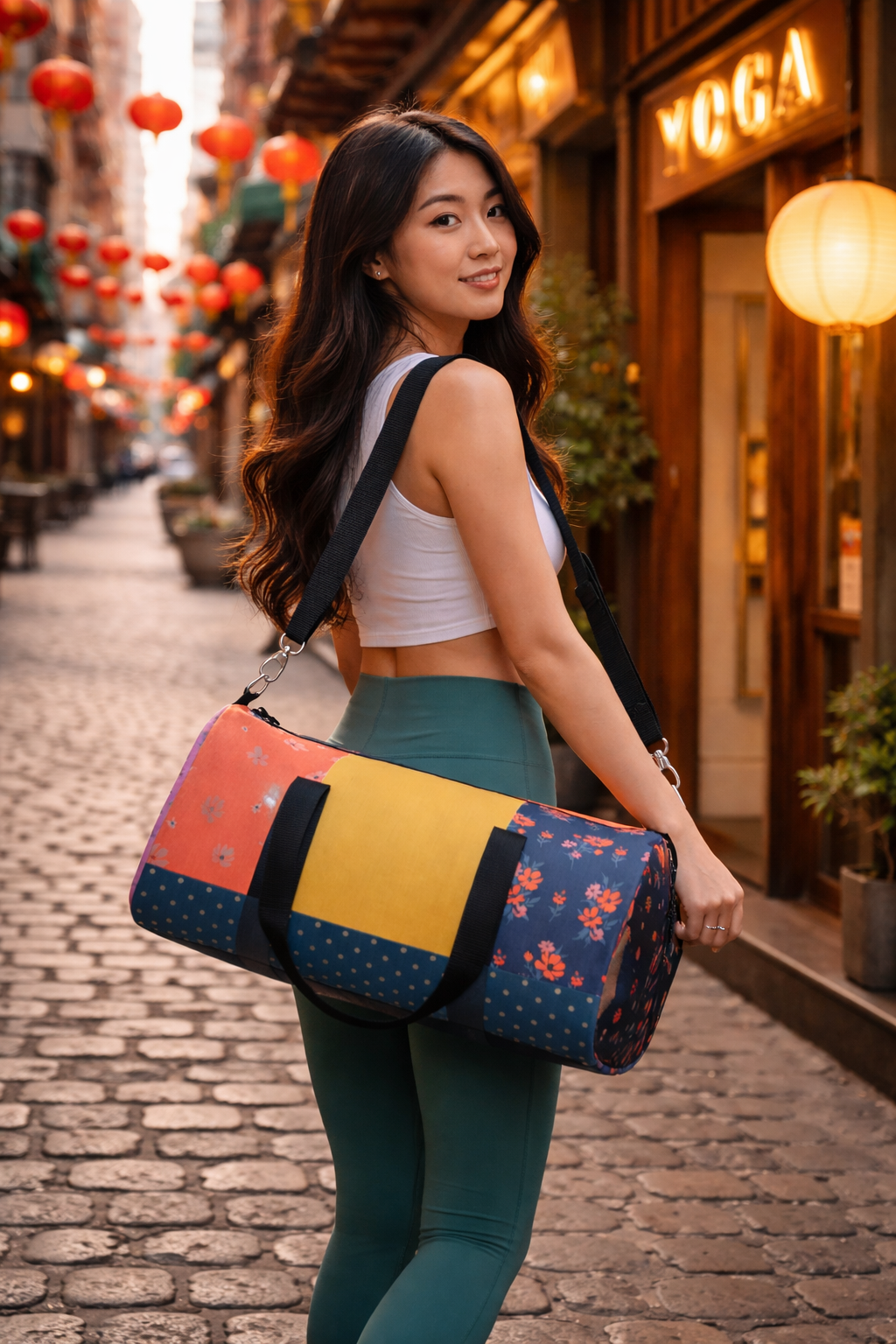 woman carrying floral patchwork duffel bag in city - colorful statement travel gym bag