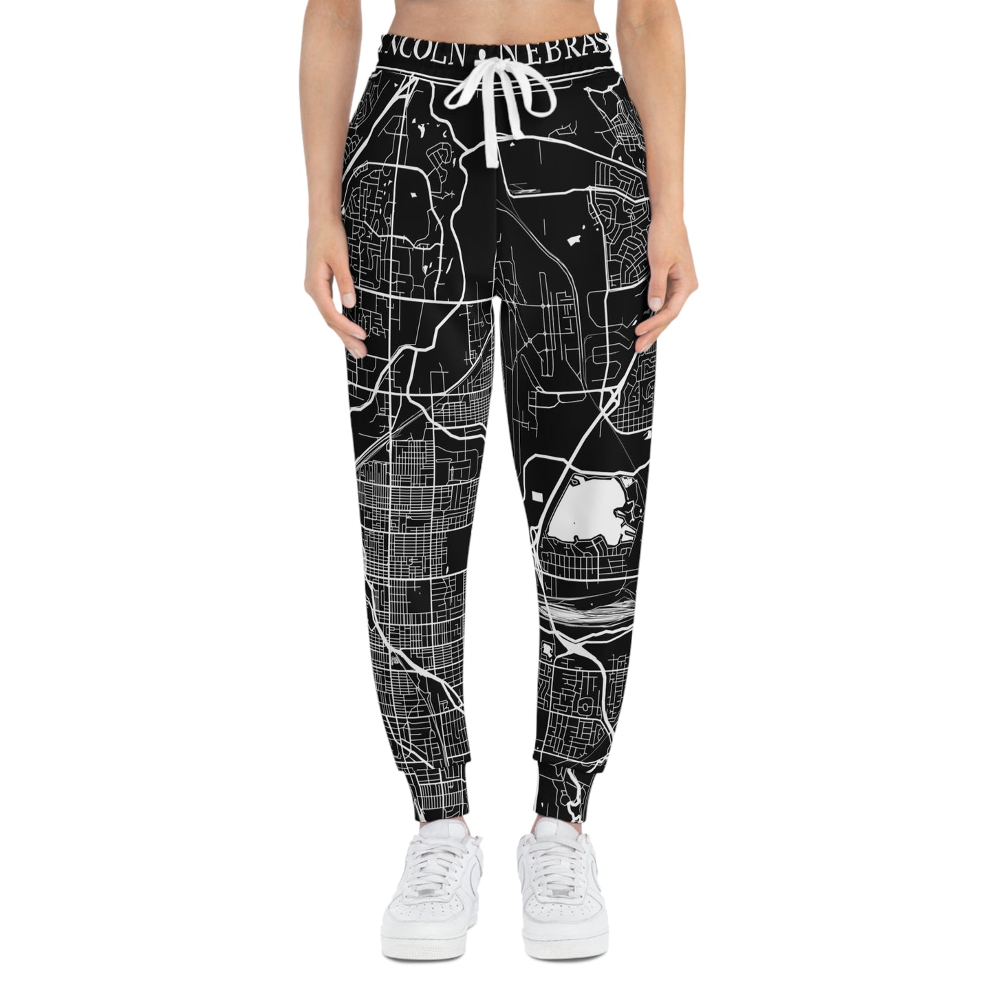 Frontal view of a female model wearing Nebraska map pattern joggers