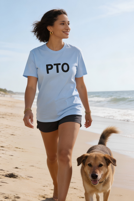Light Blue PTO T-Shirt worn by woman walking on beach with dog