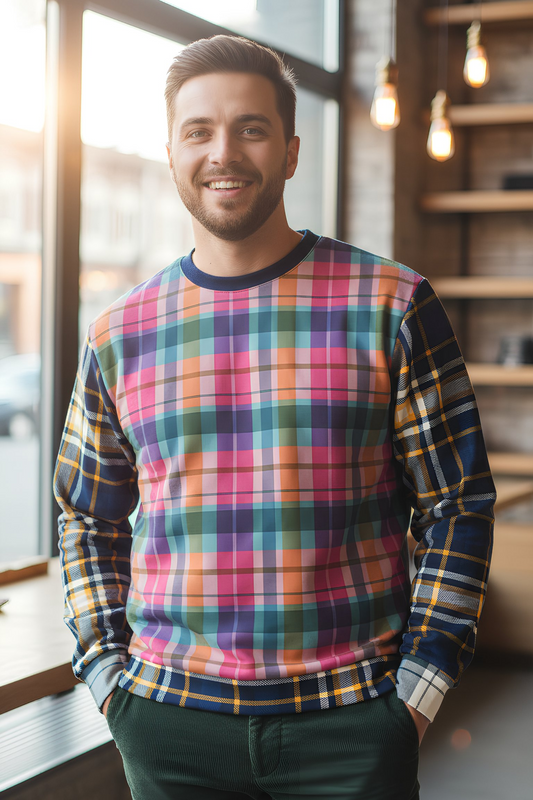 Man wearing colorful plaid sweatshirt indoors near window, casual lifestyle look