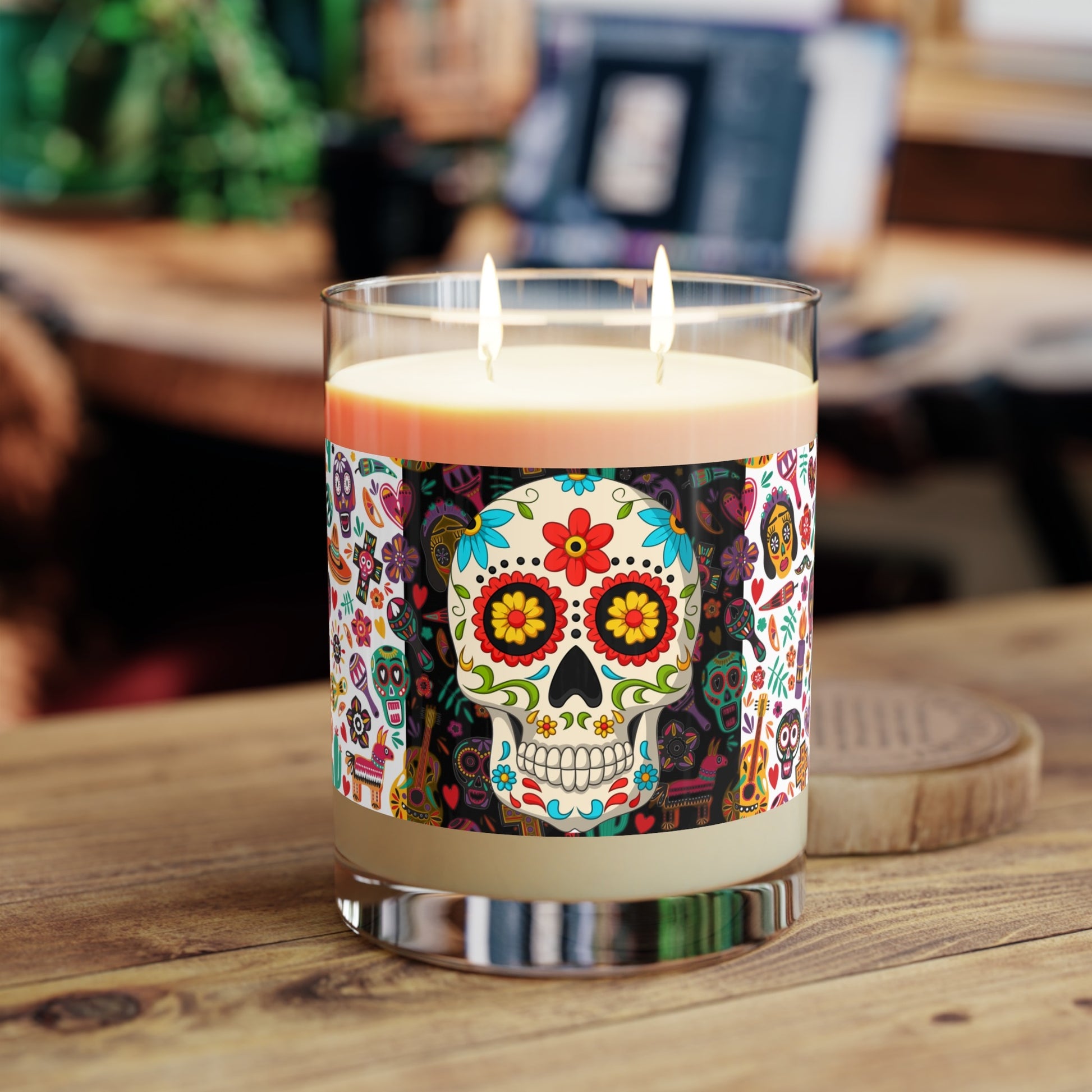 Day of the Dead skull candle on wooden desk with soft lighting