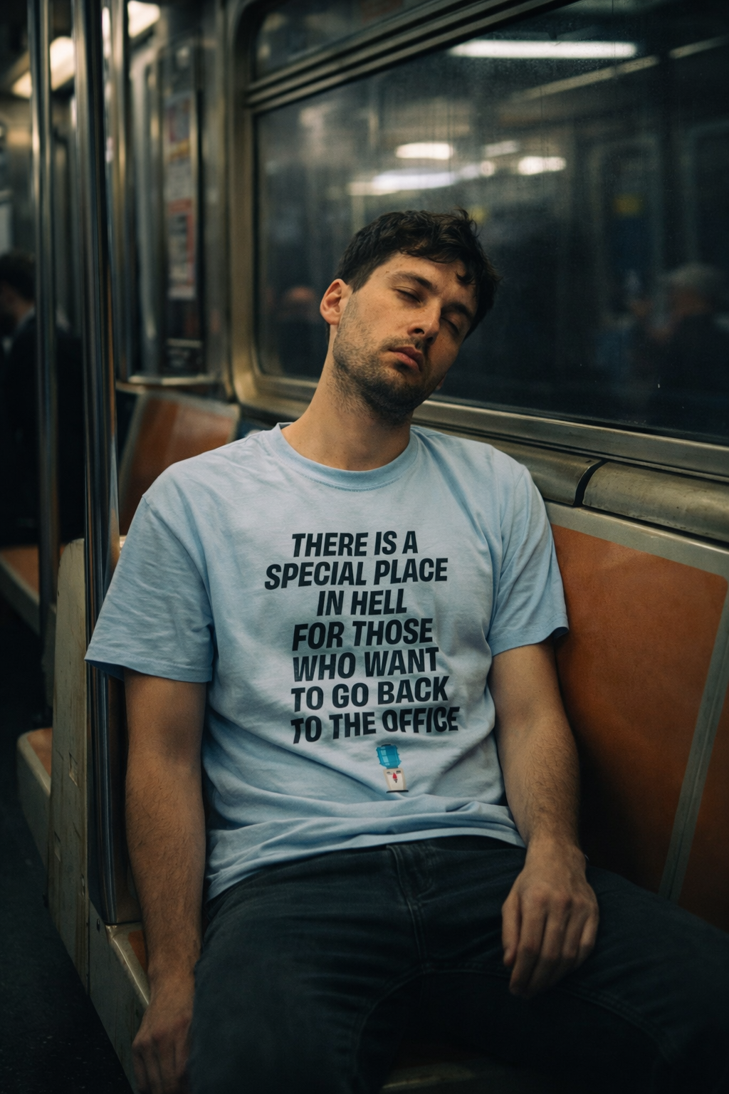 man wearing there is a special place t shirt sitting in subway tired expression
